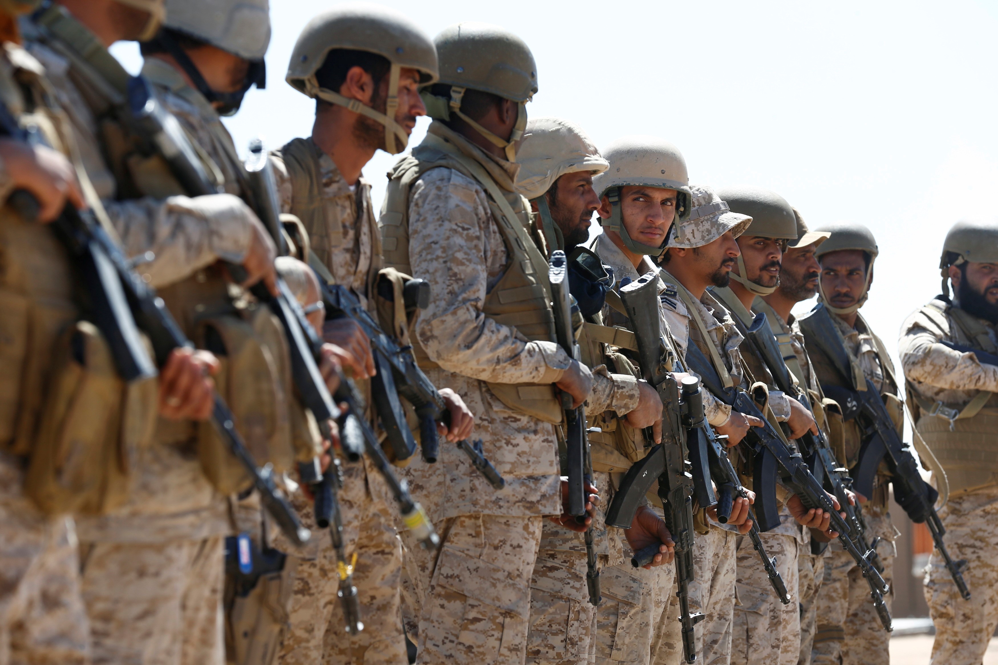 Saudi soldiers stand in line at an airfield where Saudi military cargo planes land to deliver aid in Marib, Yemen January 26, 2018. Picture taken 26 January, 2018 (Reuters)