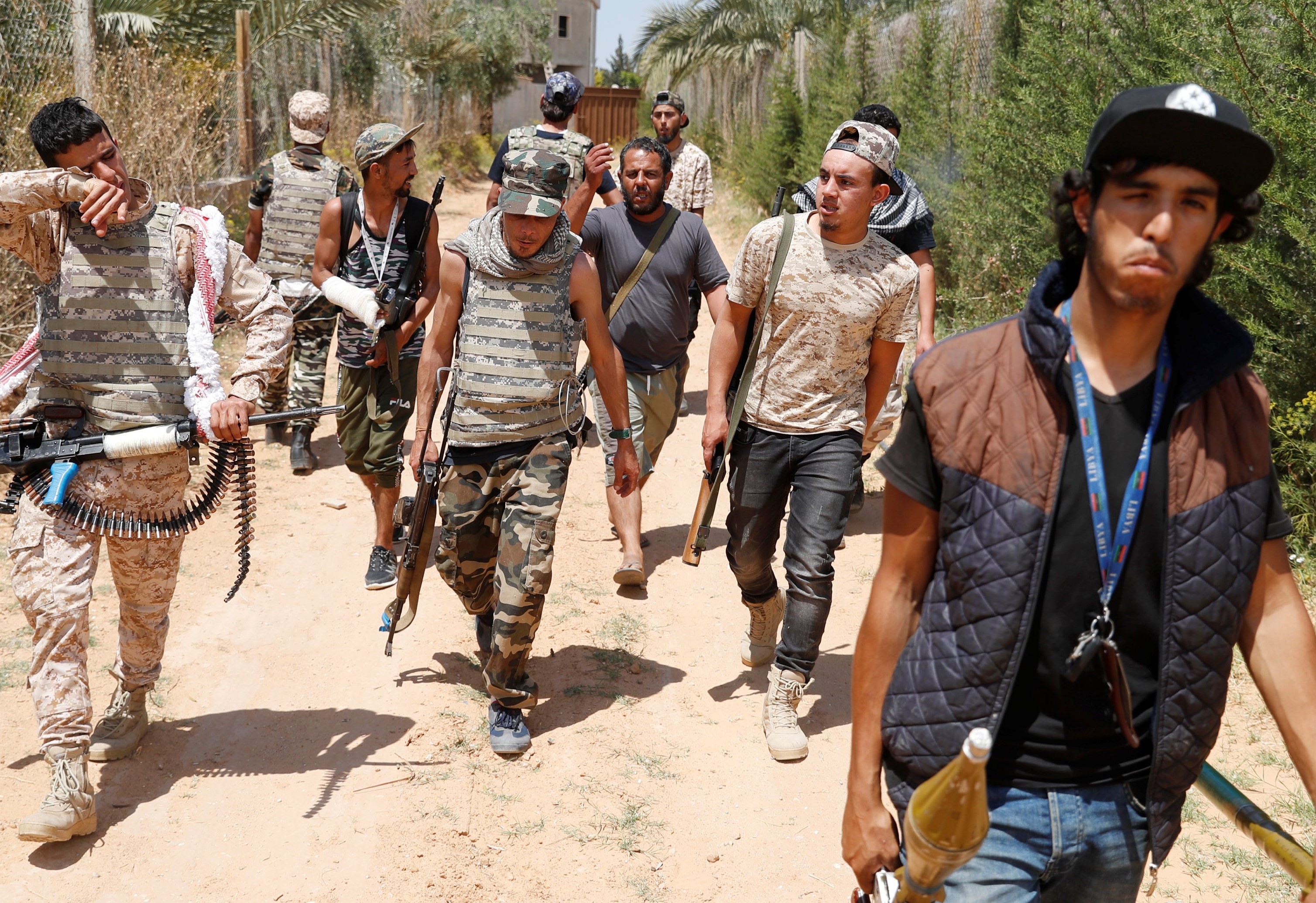 Fighters loyal to Libyan internationally recognised government walk on the frontline outside Tripoli, Libya 15 May 15 (Reuters) 