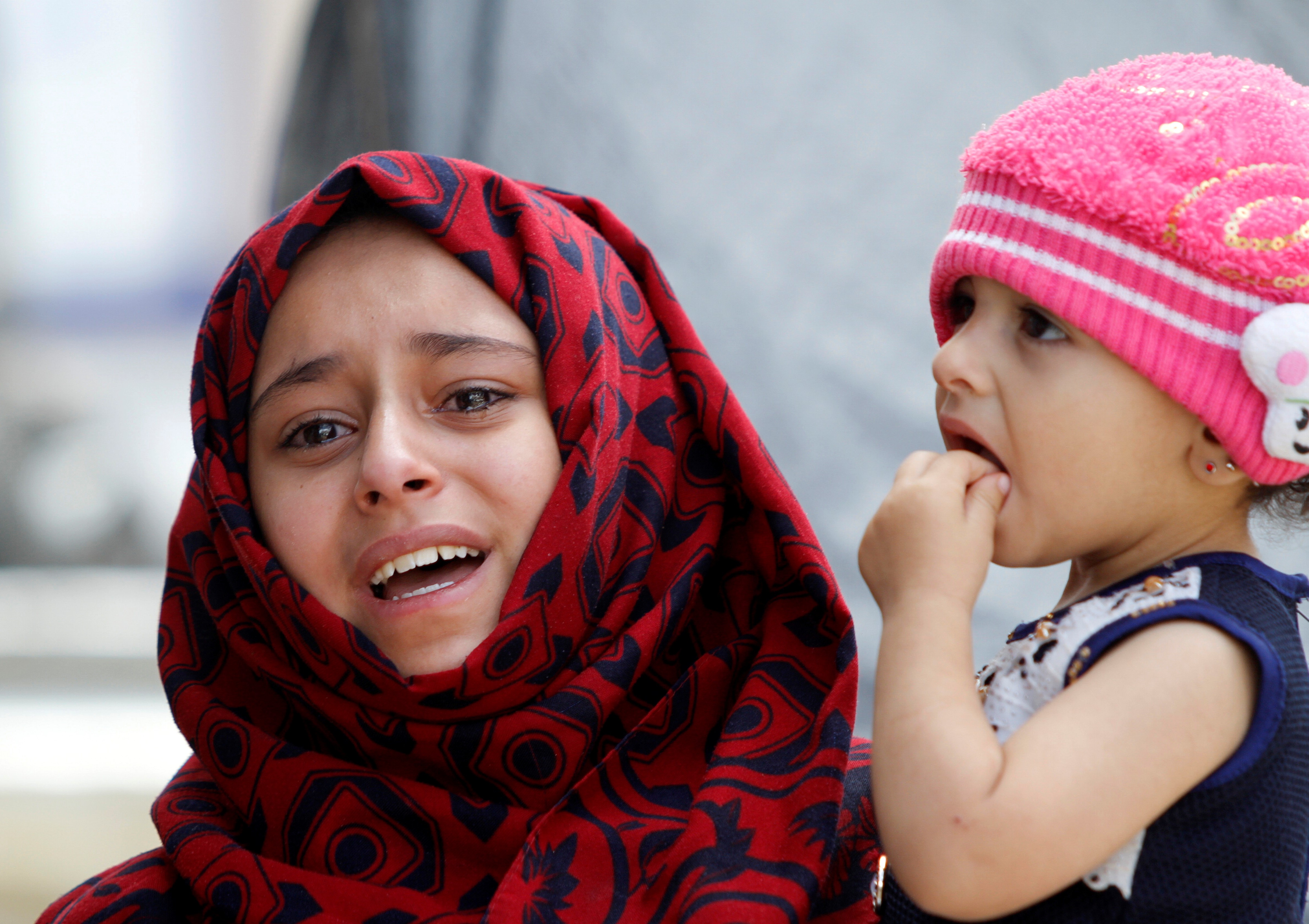 A Yemeni girl cries during the funeral of people who were killed by an air strike launched by the Saudi-led coalition in Sanaa, Yemen on 24 May (AFP)