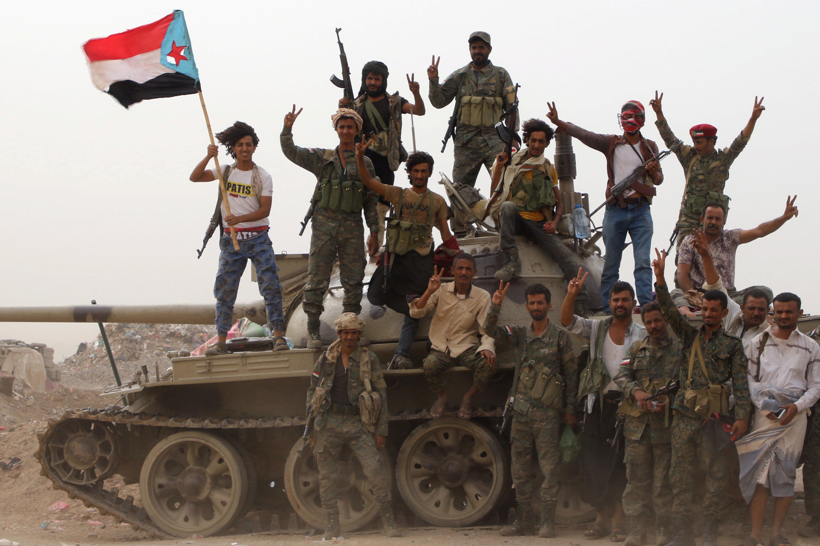Members of UAE-backed southern Yemeni separatist forces stand atop a tank during clashes with government forces in Aden, Yemen on 10 August (Reuters)