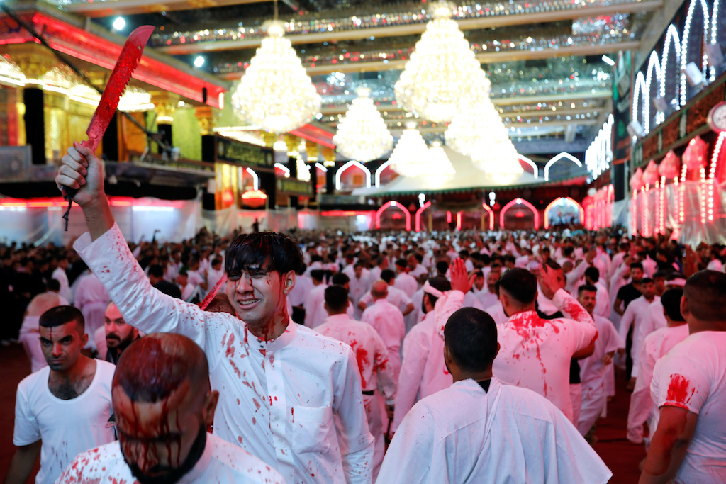 Shia Muslims men flagellate themselves during a ceremony marking Ashura in the holy city of Kerbala (Reuters)