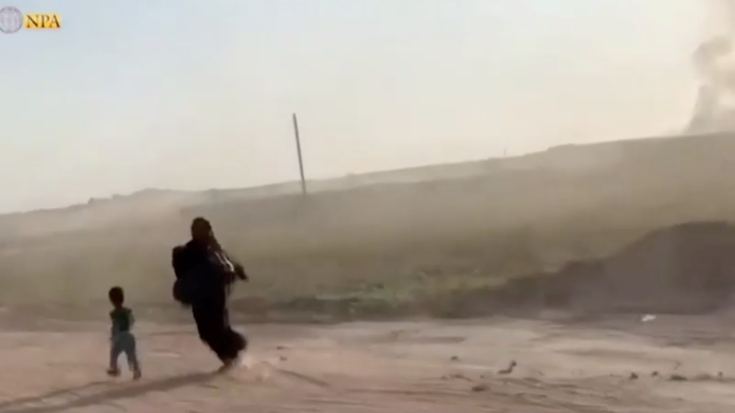 A woman and her son fleeing the village of Tal Abbyad on 9 October (Reuters)
