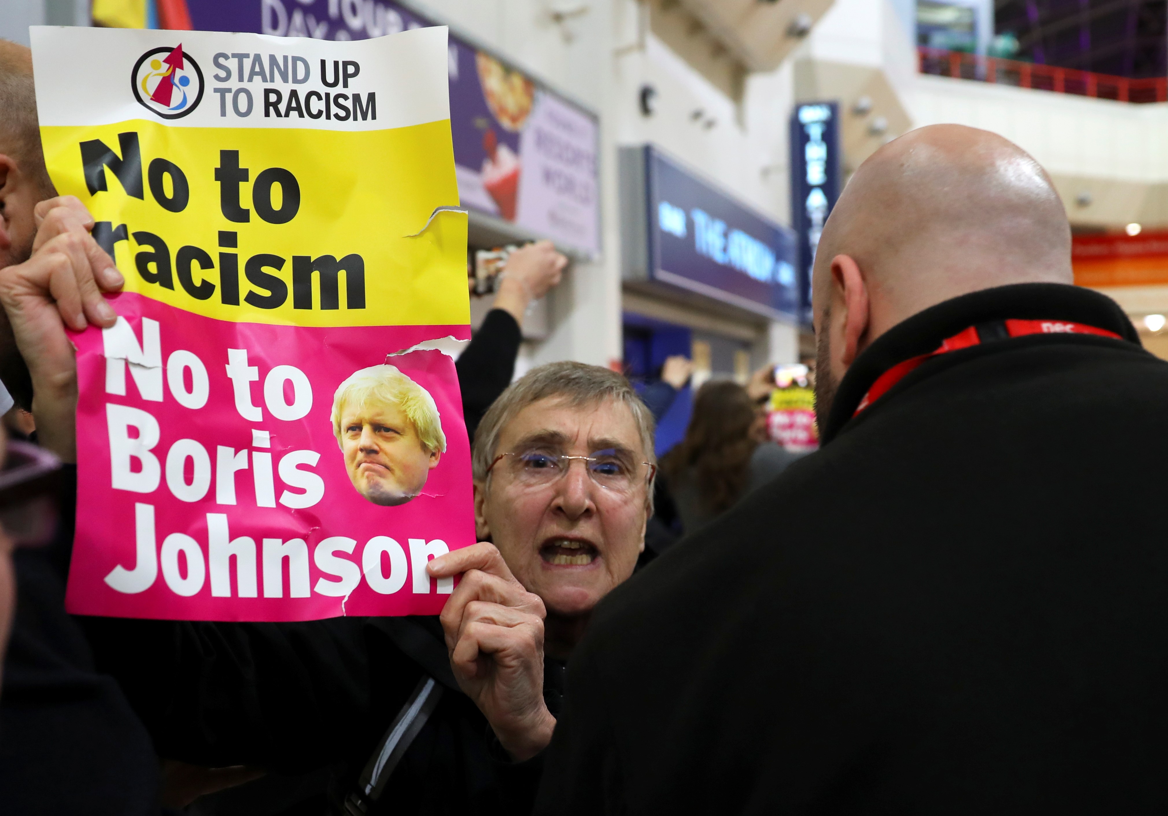  A protestor is escorted out of the venue before an event launching the Conservative Party's general election campaign in Birmingham, Britain, on 6 November (Reuters)