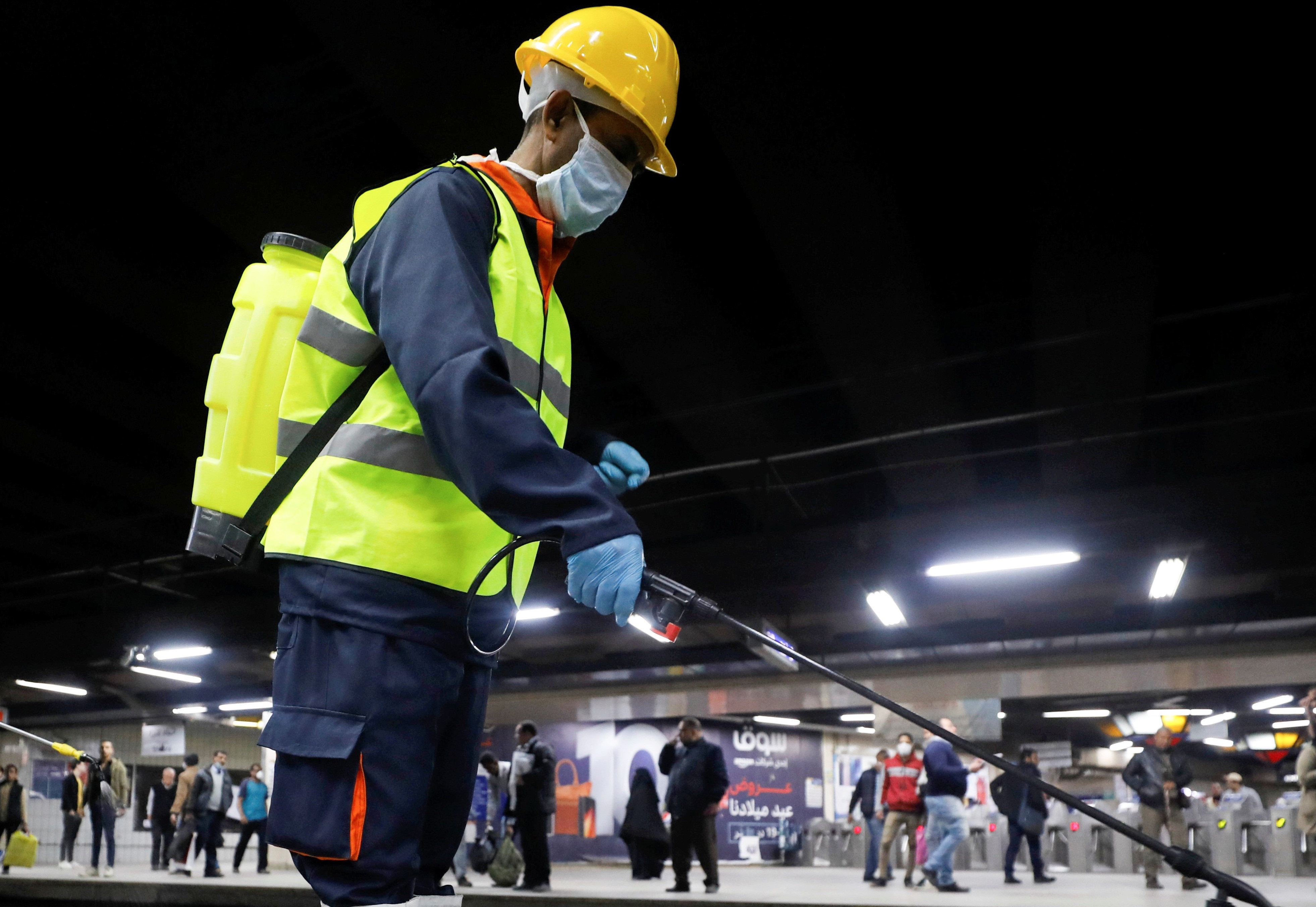   Members of medical team spray disinfectant as a precautionary move amid concerns over the coronavirus disease (COVID-19) outbreak on 22 March (Reuters)