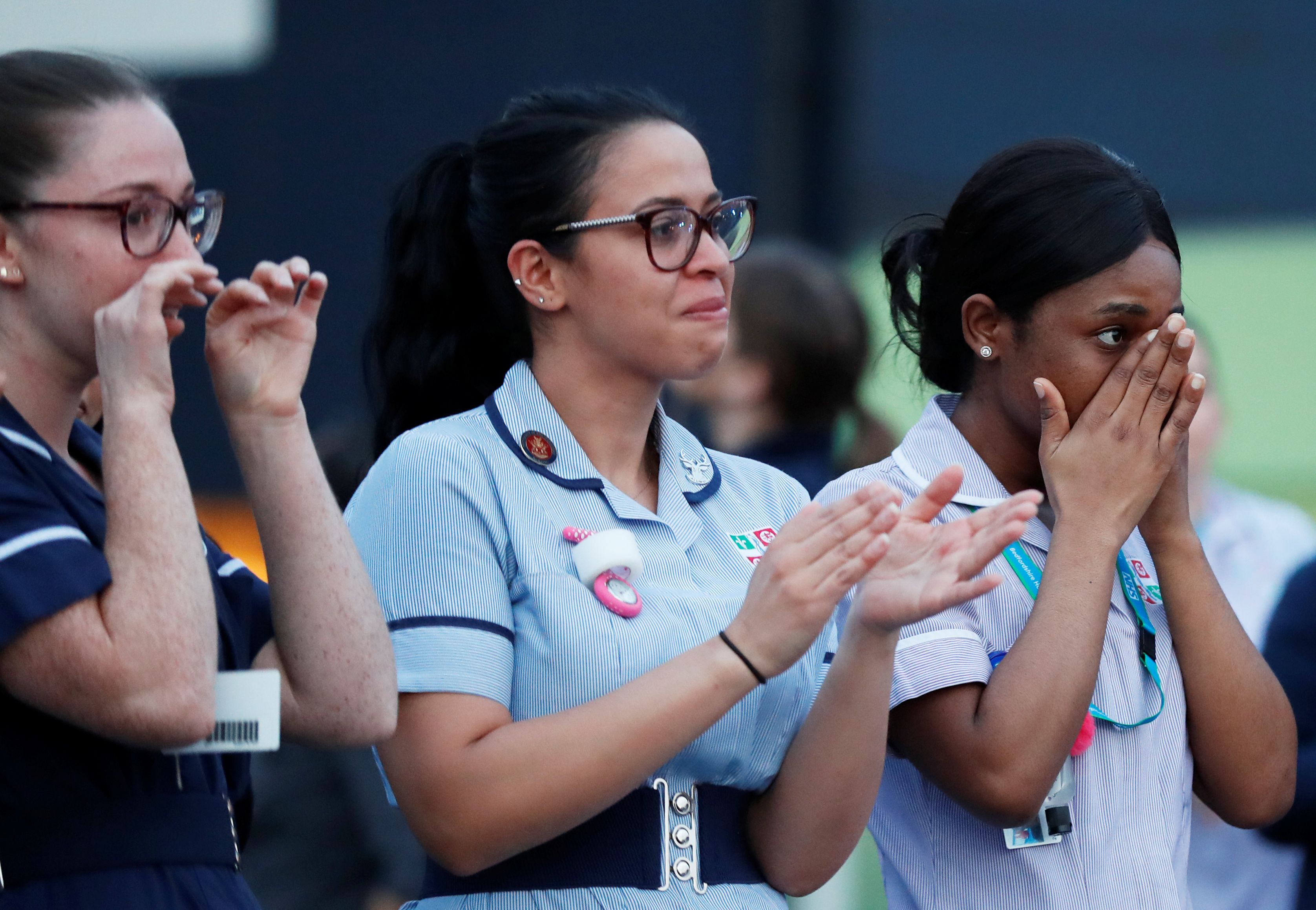 NHS workers outside Luton and Dunstable University Hospital applaud during the Clap for our Carers campaign in support of the NHS as the spread of the coronavirus disease