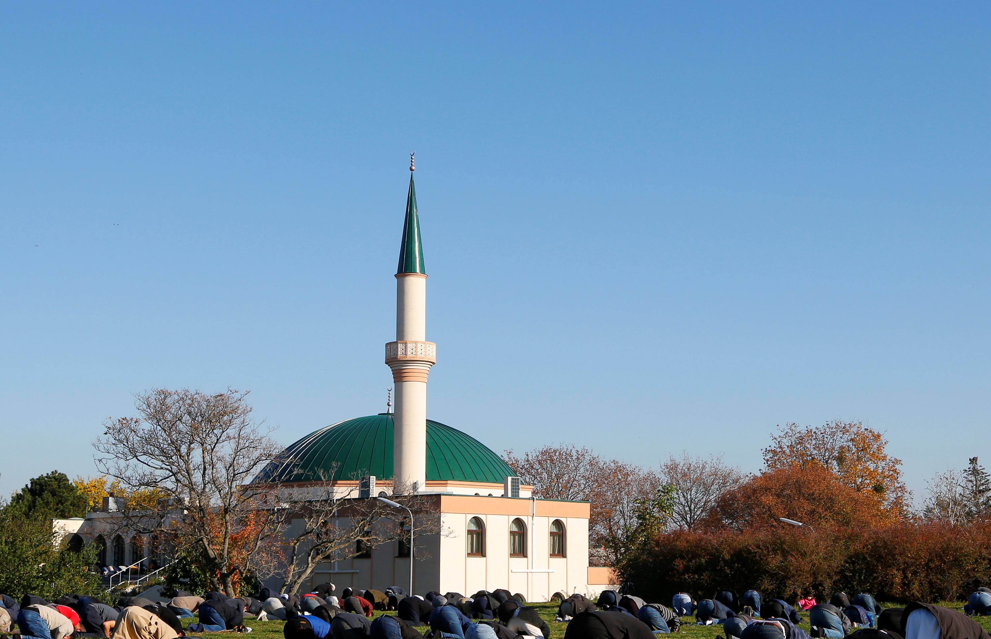 Muslims pray for victims of a gun attack during their Friday prayer, outside the mosque in Vienna, Austria November 6, 2020.