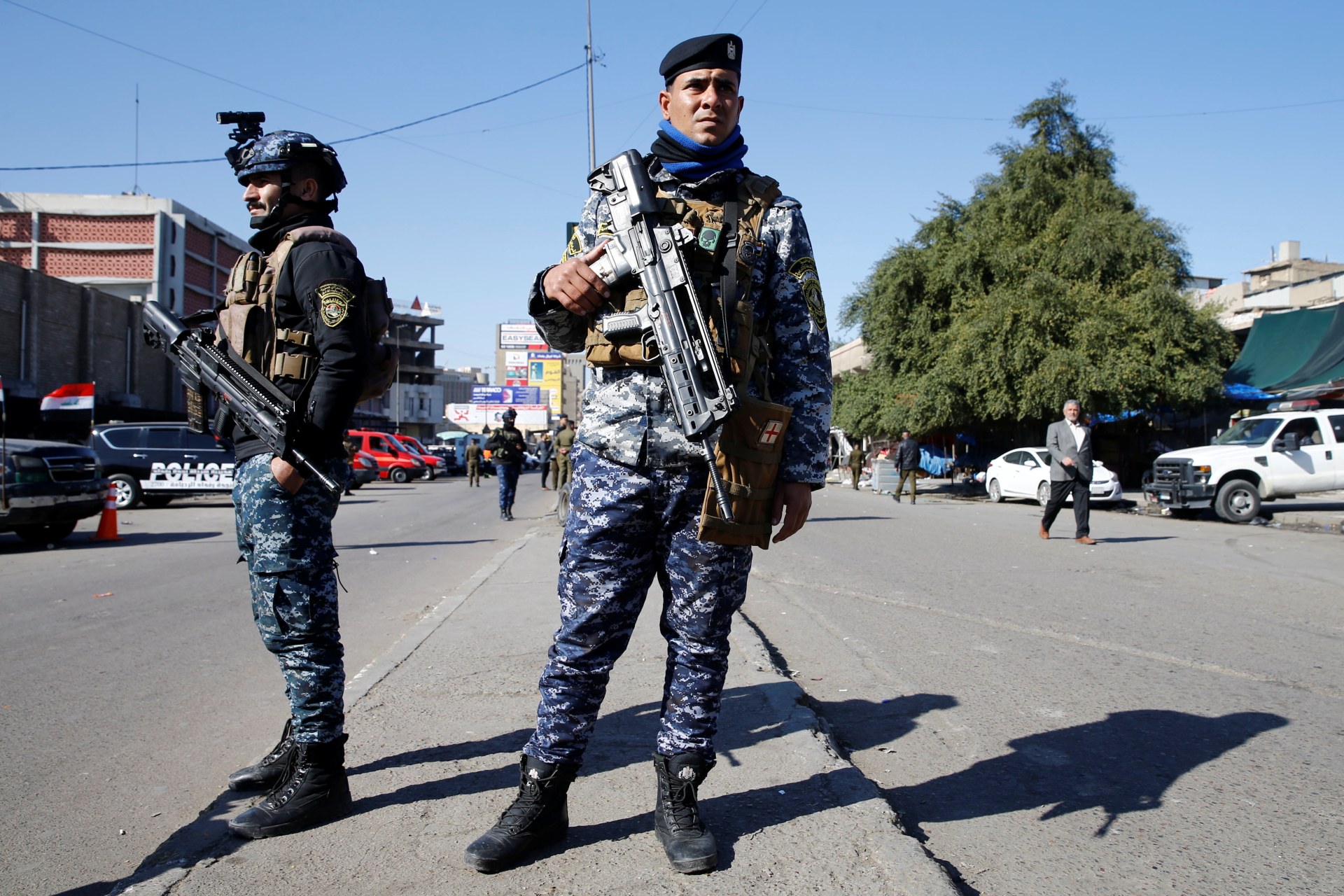 Members of Iraqi security forces keep guard at the site of a twin suicide bombing attack in a central market in Baghdad (Reuters)