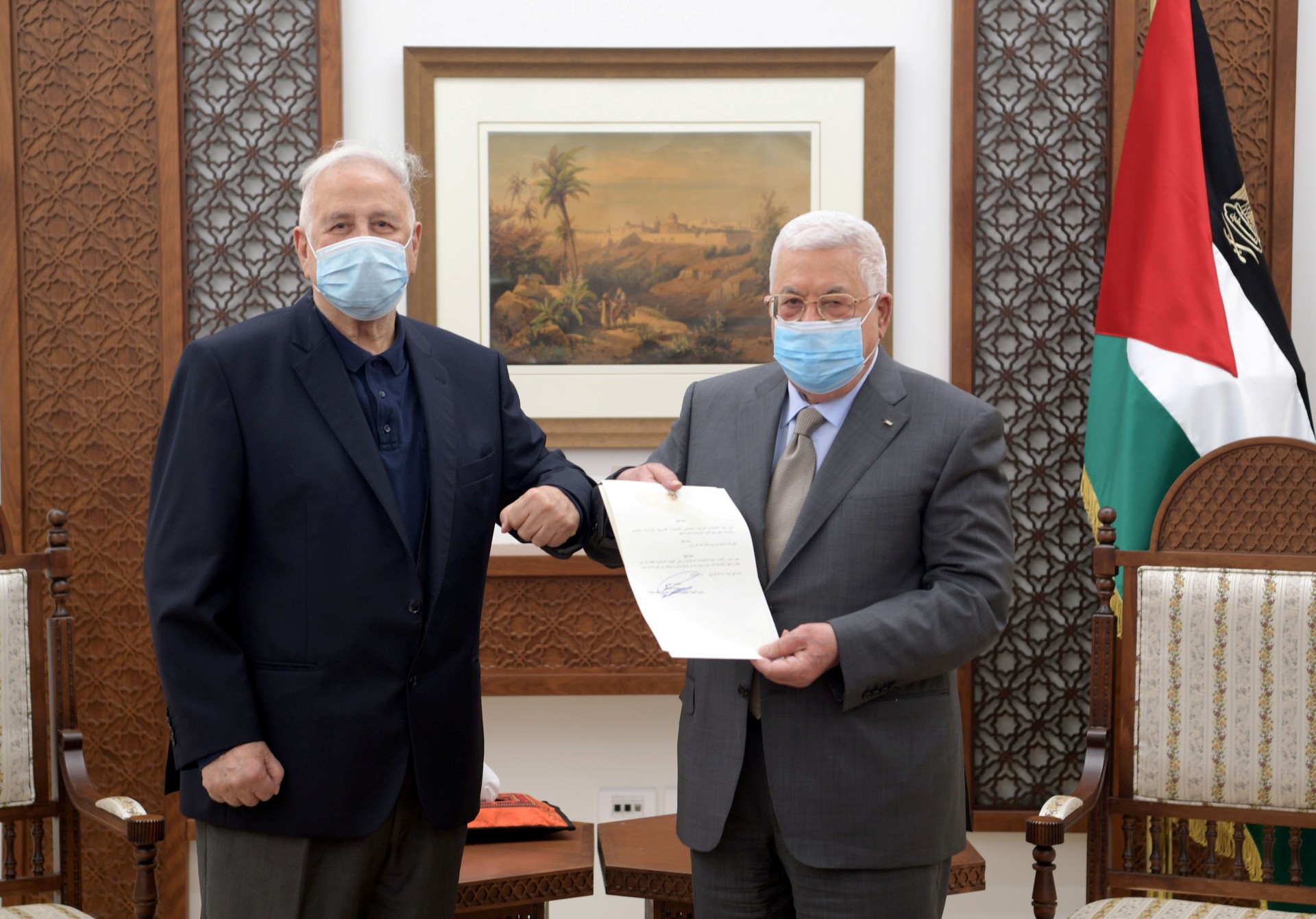 Palestinian President Mahmoud Abbas hands the election decree to Chairman of the Palestinian Central Election Committee Hana Naser in Ramallah in the Israeli-occupied West Bank (Reuters)