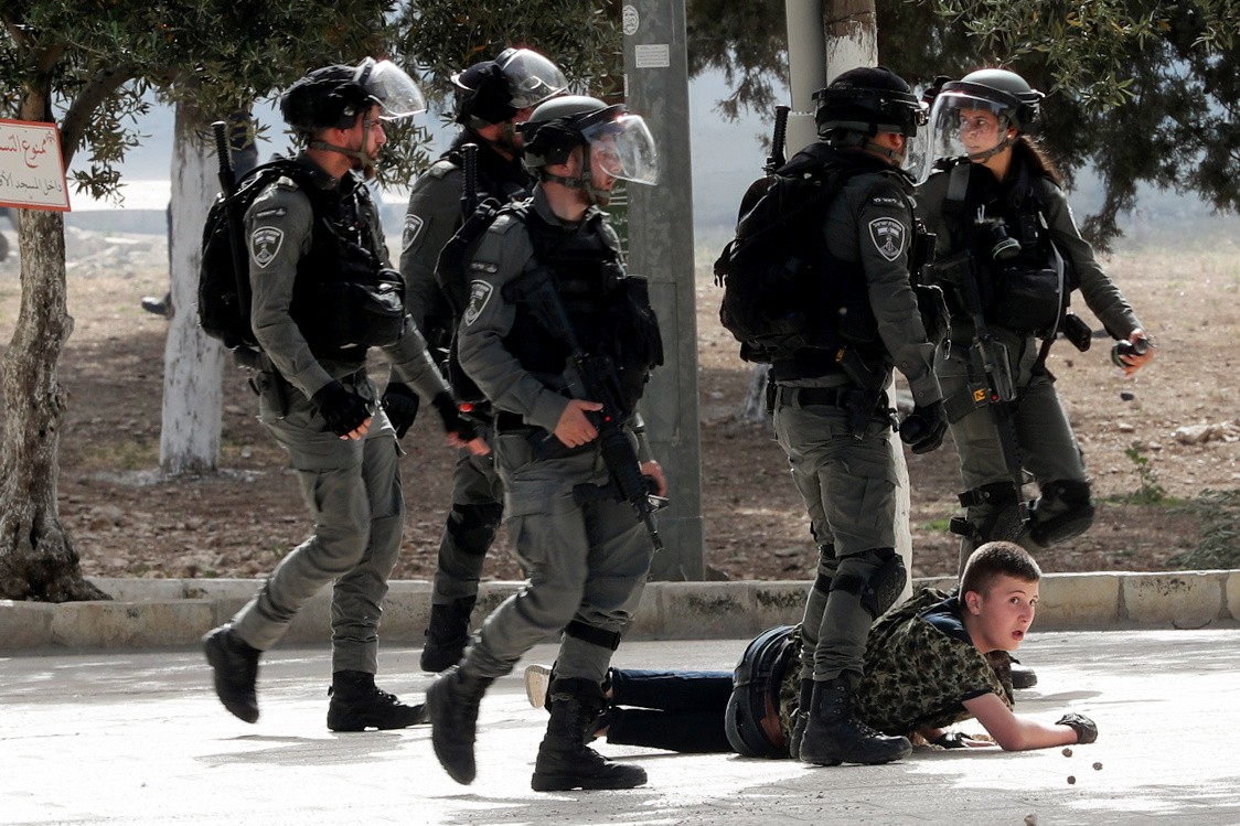 Israeli police detain a Palestinian at al-Aqsa Mosque (Reuters)