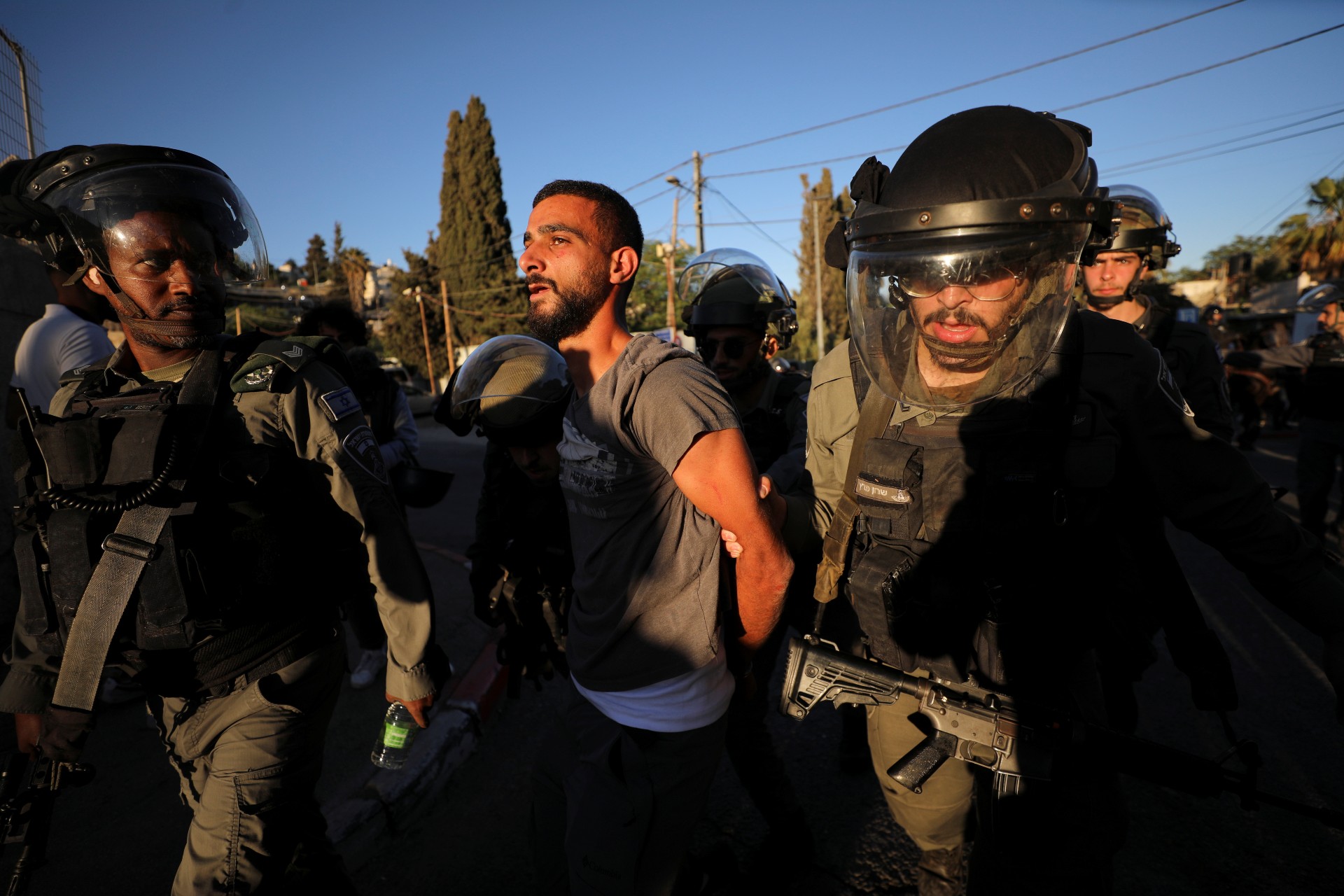 Israeli police forces detain a Palestinian protester on a street in East Jerusalem (Reuters)