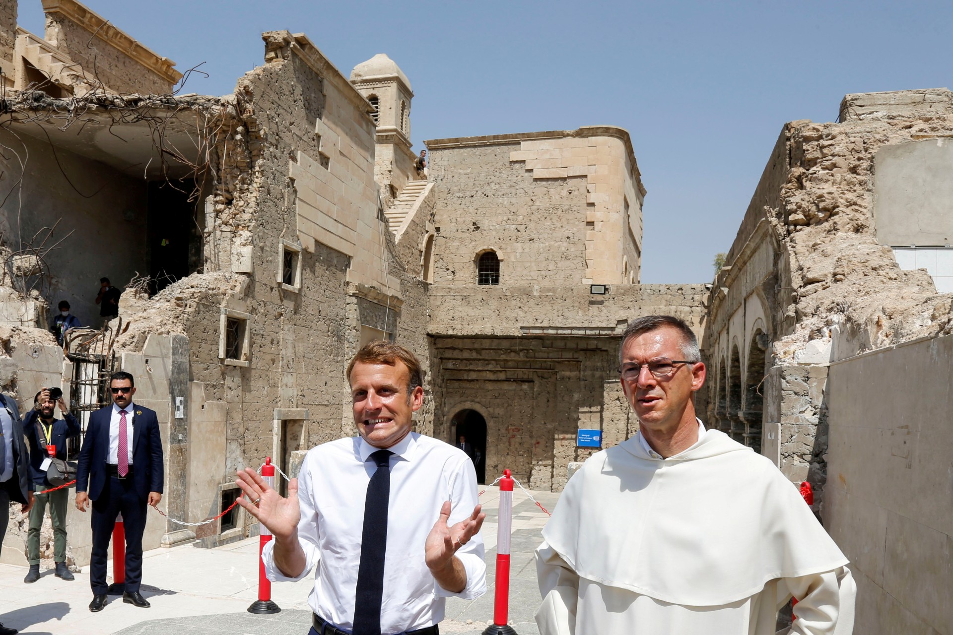 French President Emmanuel Macron gestures as he visits Al-Sa'ah church in the Old City of Mosul (Reuters)