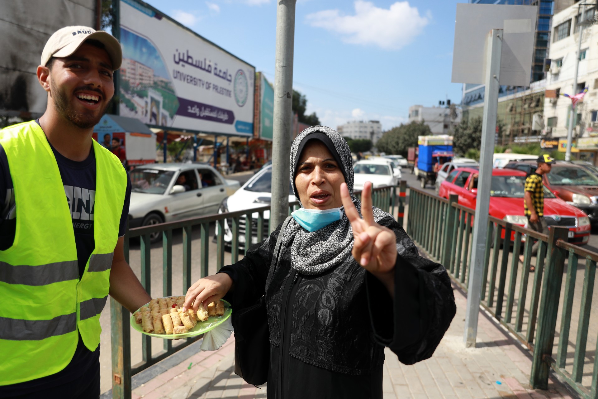 A Palestinian man passes out sweets in the street in Gaza City after six Palestinian prisoners escaped from the Gilboa prison in north Israel (Reuters)