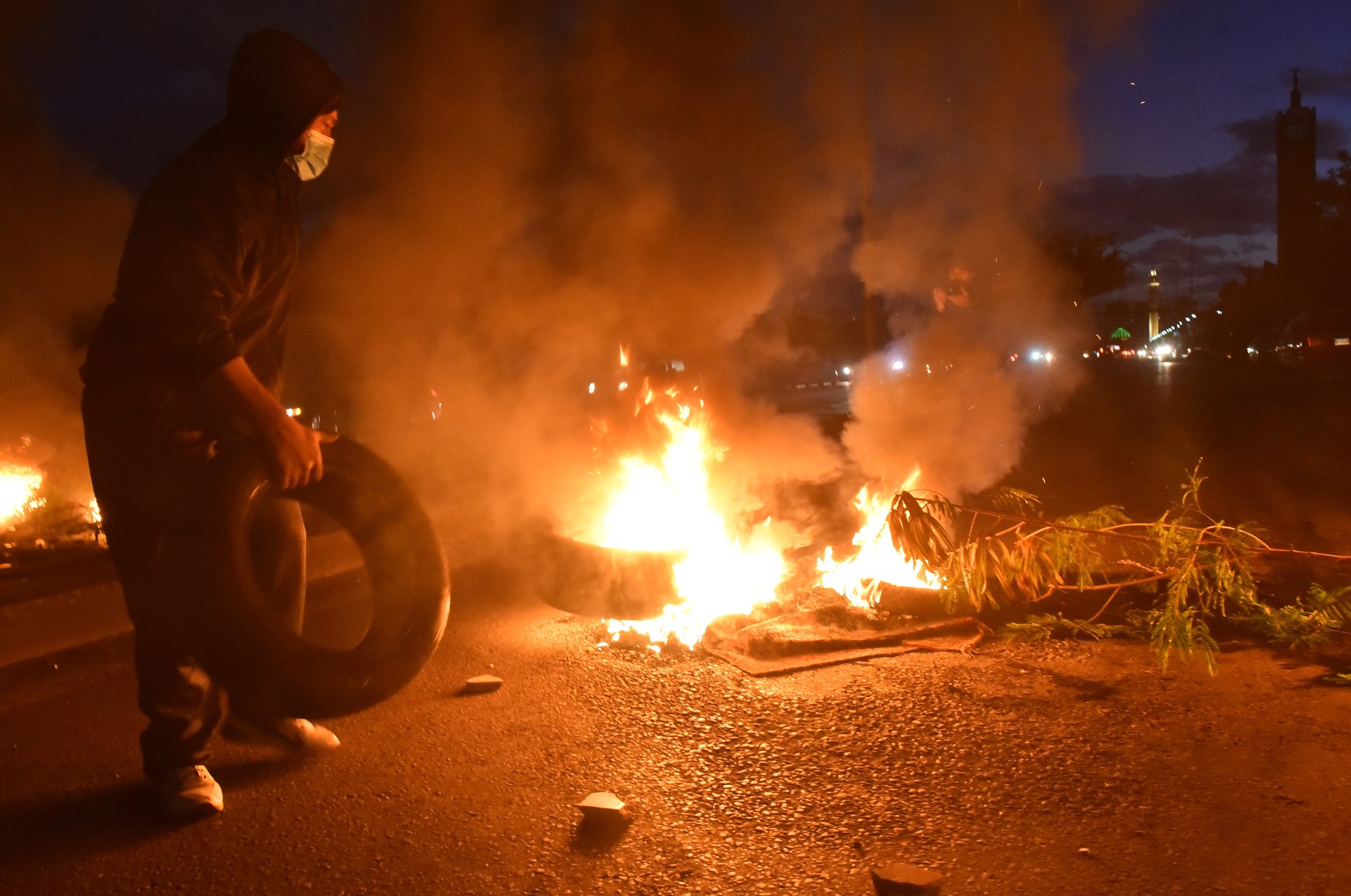 Supporters of Saad Hariri in Beirut stage a demonstration by blocking the roads, after he announced he was suspending his work in politics (Reuters)