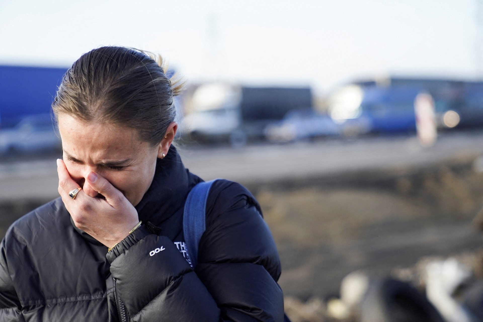 An American woman cries after crossing the border and fleeing the violence in Ukraine, in Medyka, Poland (Reuters)