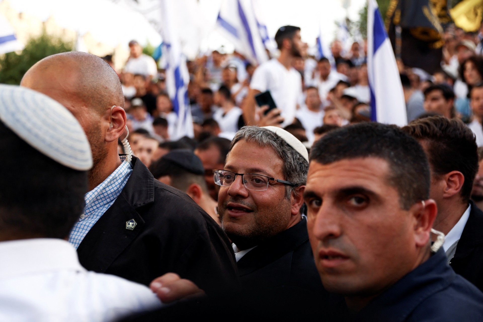Israeli far-right MP Itamar Ben-Gvir is escorted by bodyguards as he visits Damascus Gate to Jerusalem's Old City as part of the Jerusalem Day events 29 May (Reuters)