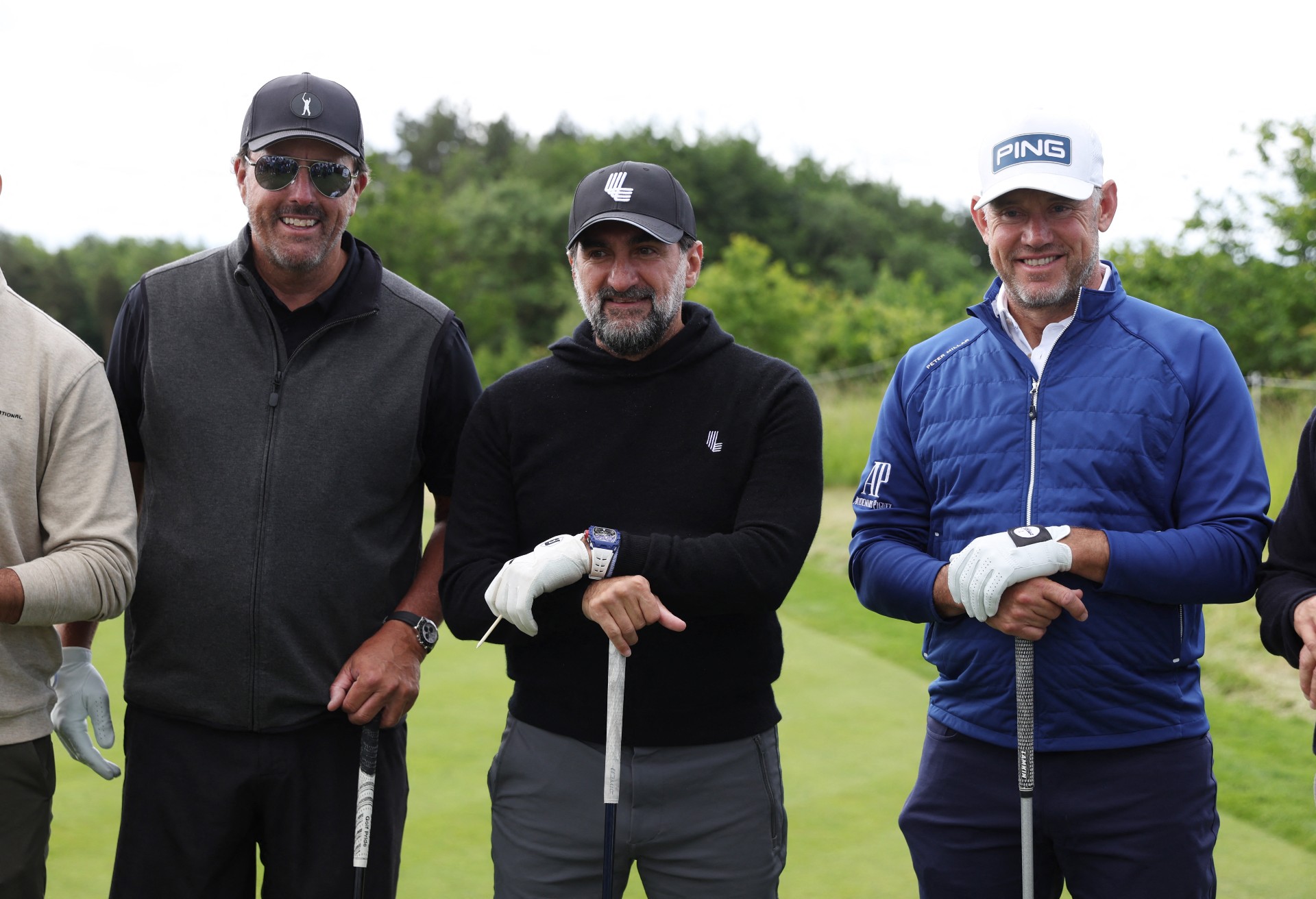 Phil Mickelson of the U.S. and England's Lee Westwood pose with Newcastle United chairman Yasir Al-Rumayyan (Reuters)