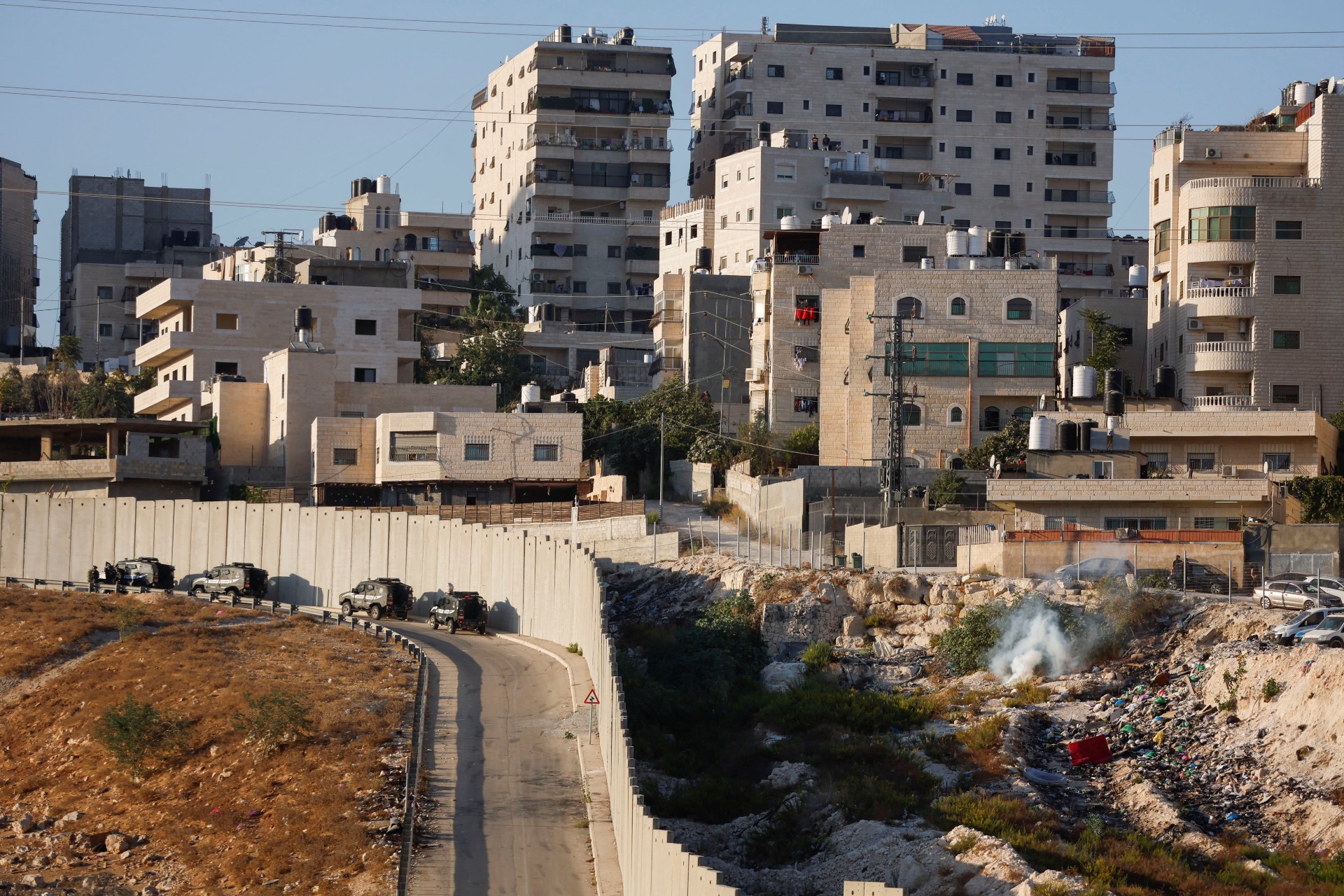 Israeli police patrol the outskirts of Shuafat refugee camp as part of a manhunt on 9 October (Reuters)
