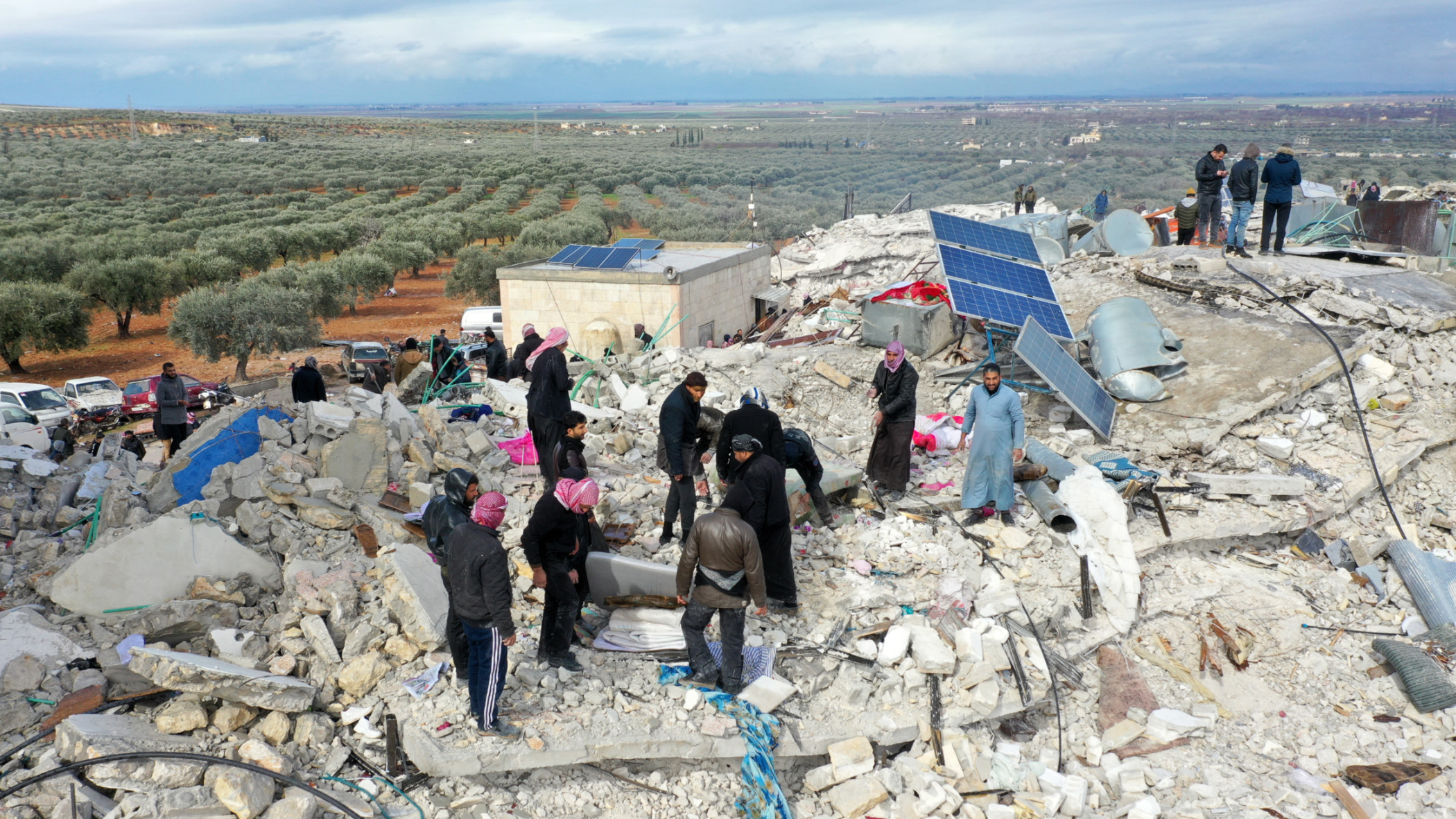 Residents searching for victims and survivors amidst the rubble of collapsed buildings in the environs of Harim town in Syria's Idlib province, north of the country, on the border with Turkey, on Monday 6 February (AFP).