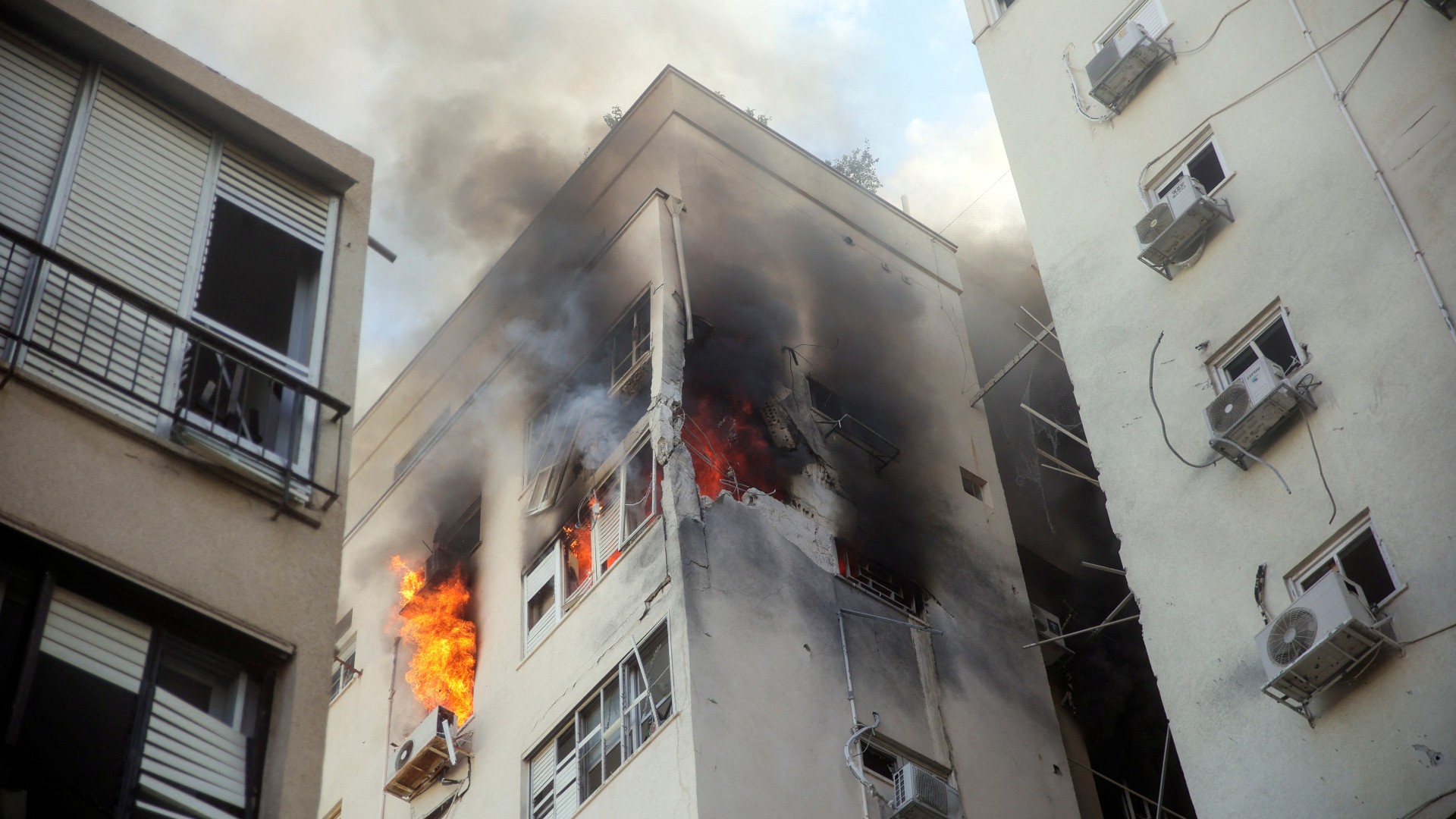 A residential building on fire after being hit by a rocket in Tel Aviv (Reuters)
