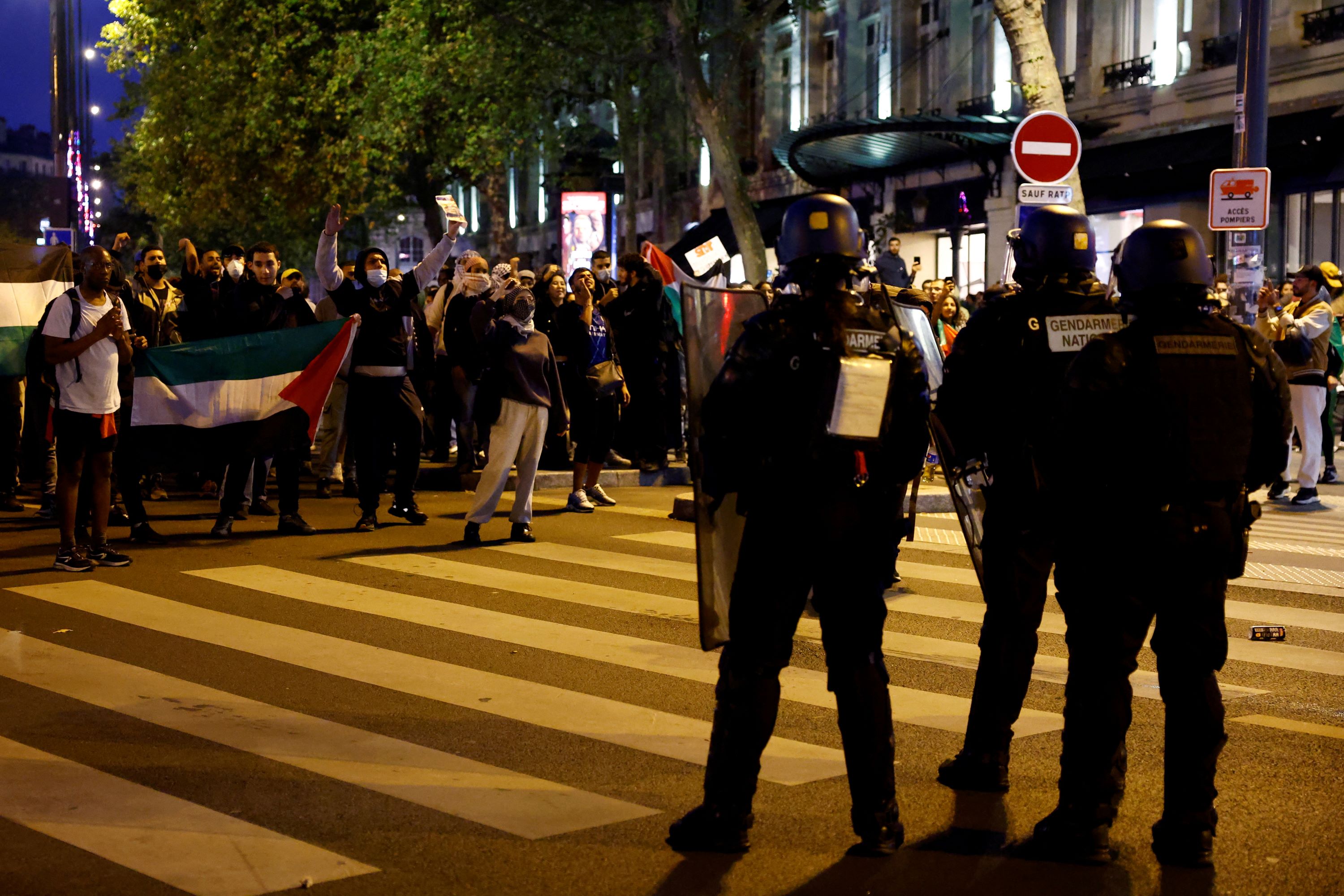 Protesters face off with French gendarmes during an unauthorized demonstration in support of Palestinians, as part of the ongoing conflict between Israel and Hamas (Reuters)