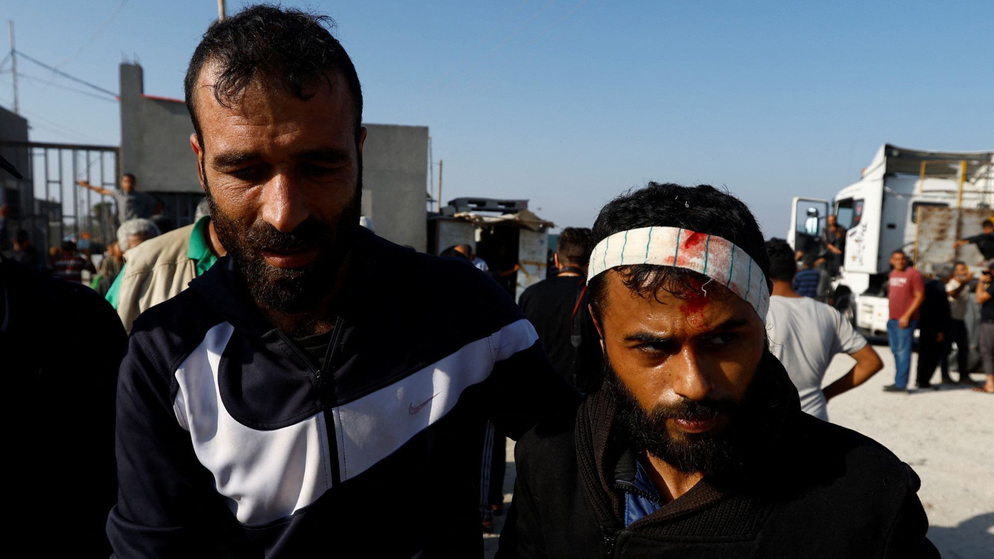 A Palestinian labourer is welcomed as he arrives in Gaza after being sent back by Israel on 3 November 2023 (Reuters)