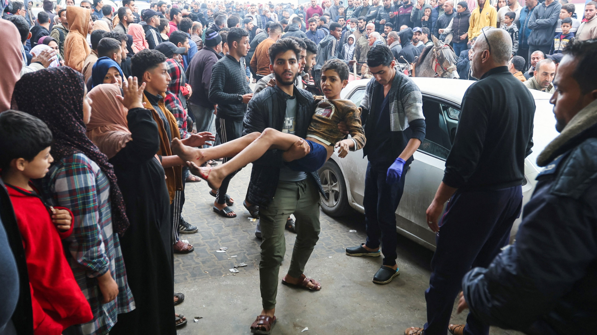 A wounded Palestinian child is brought into Nasser hospital, following Israeli strikes on Ma'an school east of Khan Younis (Reuters)