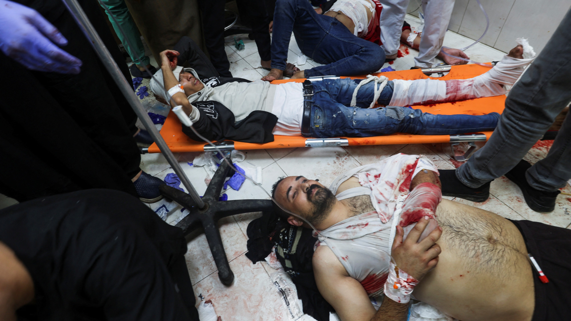Wounded Palestinians lie on the floor at Nasser hospital after Israeli strikes in Khan Younis (Reuters)