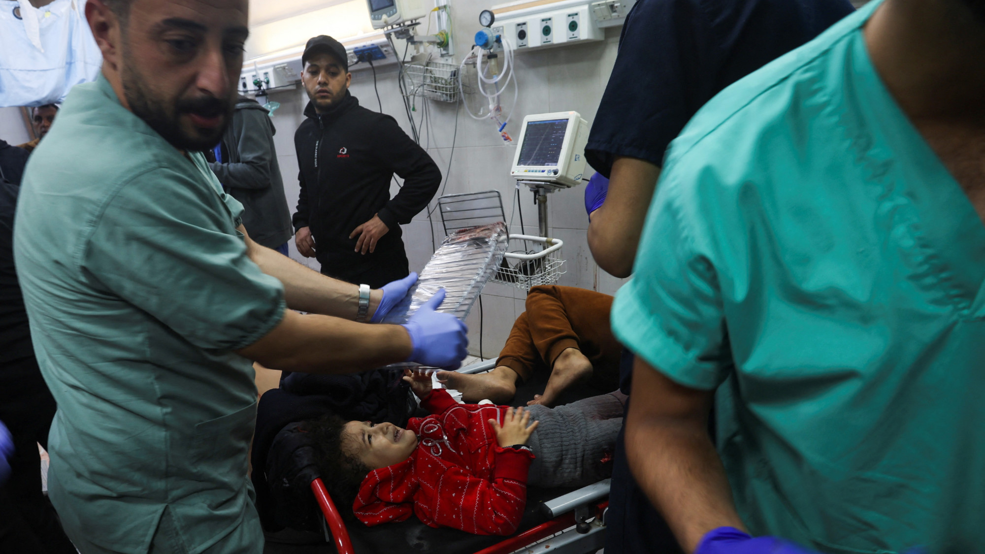 Palestinian nurse assists a wounded child at Nasser hospital following Israeli strikes on Ma'an school in Khan Younis (Reuters)