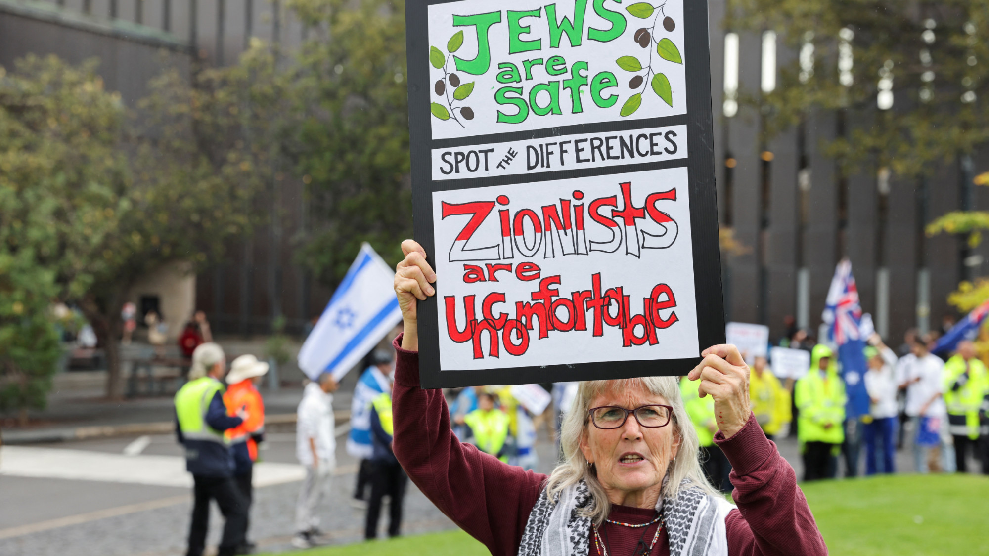 A protester supporting Palestinians in Gaza holds up a sign during a rally at The University of Sydney on 3 May 2024 (Reuters/Lewis Jackson)