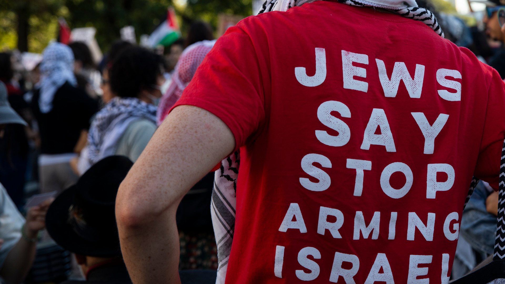 A protester wears a red shirt with the text ''Jews Say Stop Arming Israel'' during a pro-Palestinian rally as part of an international day of action near the White House in Washington DC, USA, on 5 October 2024 (Aashish Kiphayet/NurPhoto)