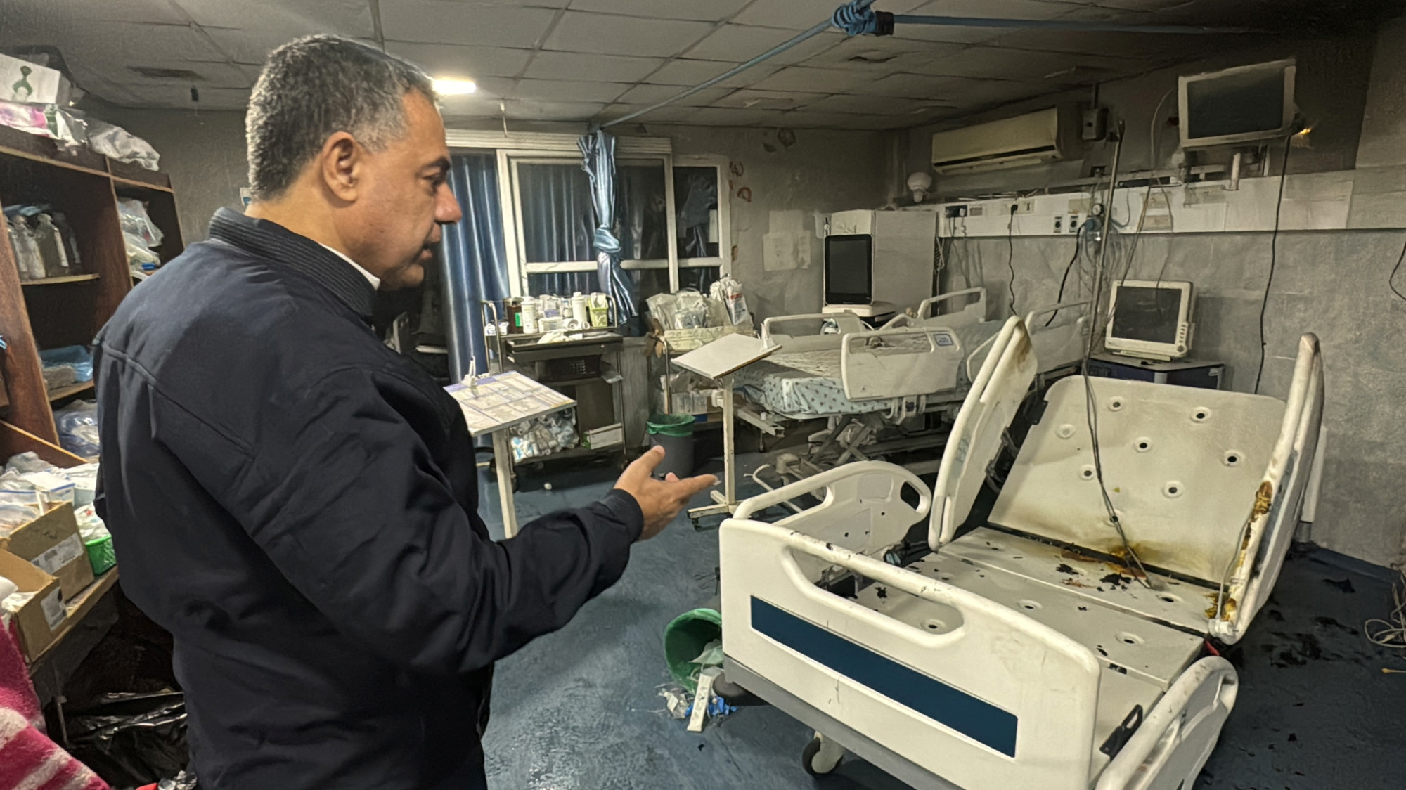 Dr Abu Safiya shows the damage inside the Kamal Adwan hospital from Israeli fire in the northern Gaza Strip on 18 December 2024 (Reuters)