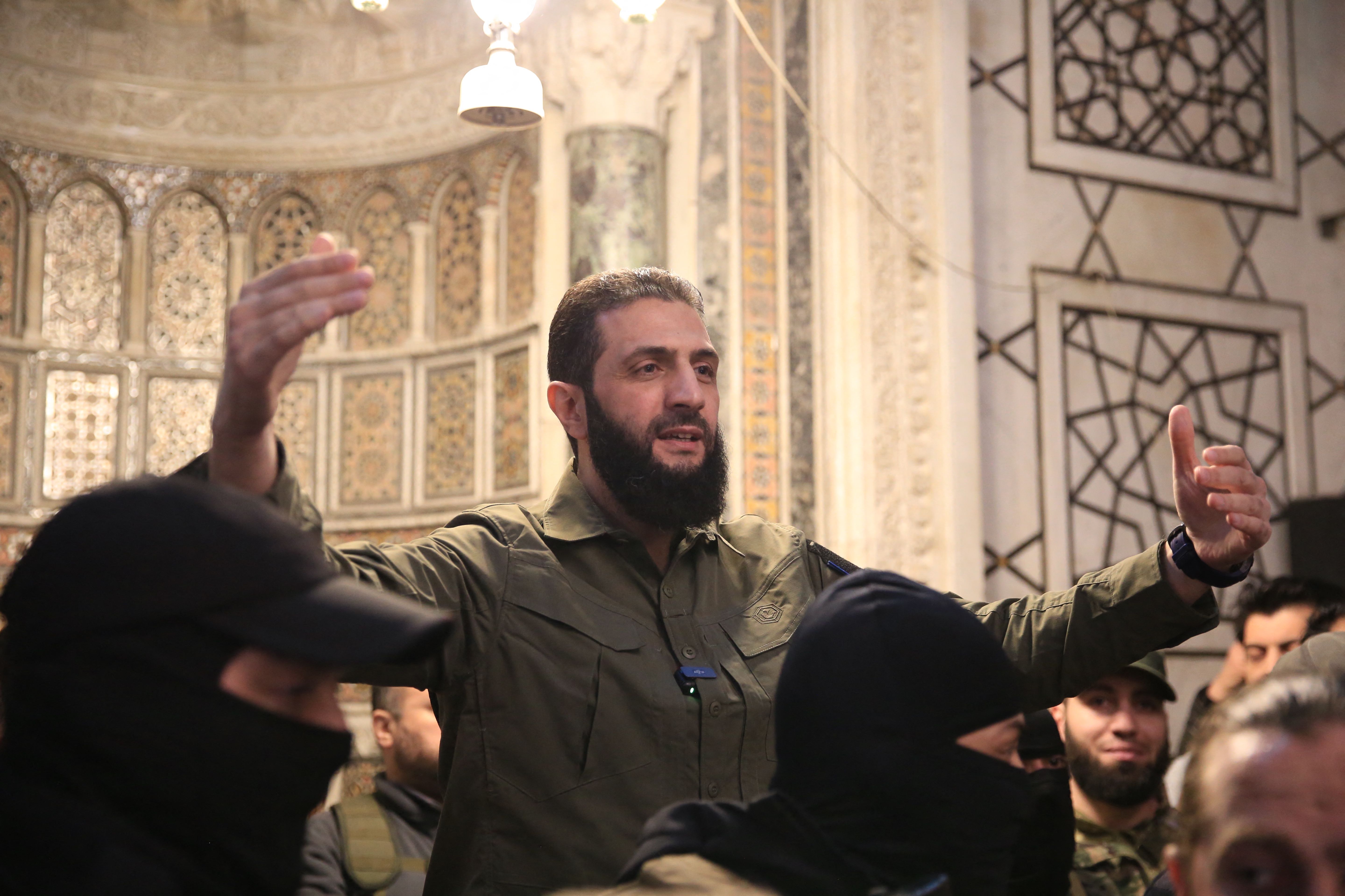 Ahmed al-Sharaa, more commonly known as Abu Mohammad al-Jolani, in Damascus' Umayyad Mosque on 8 December (AFP)