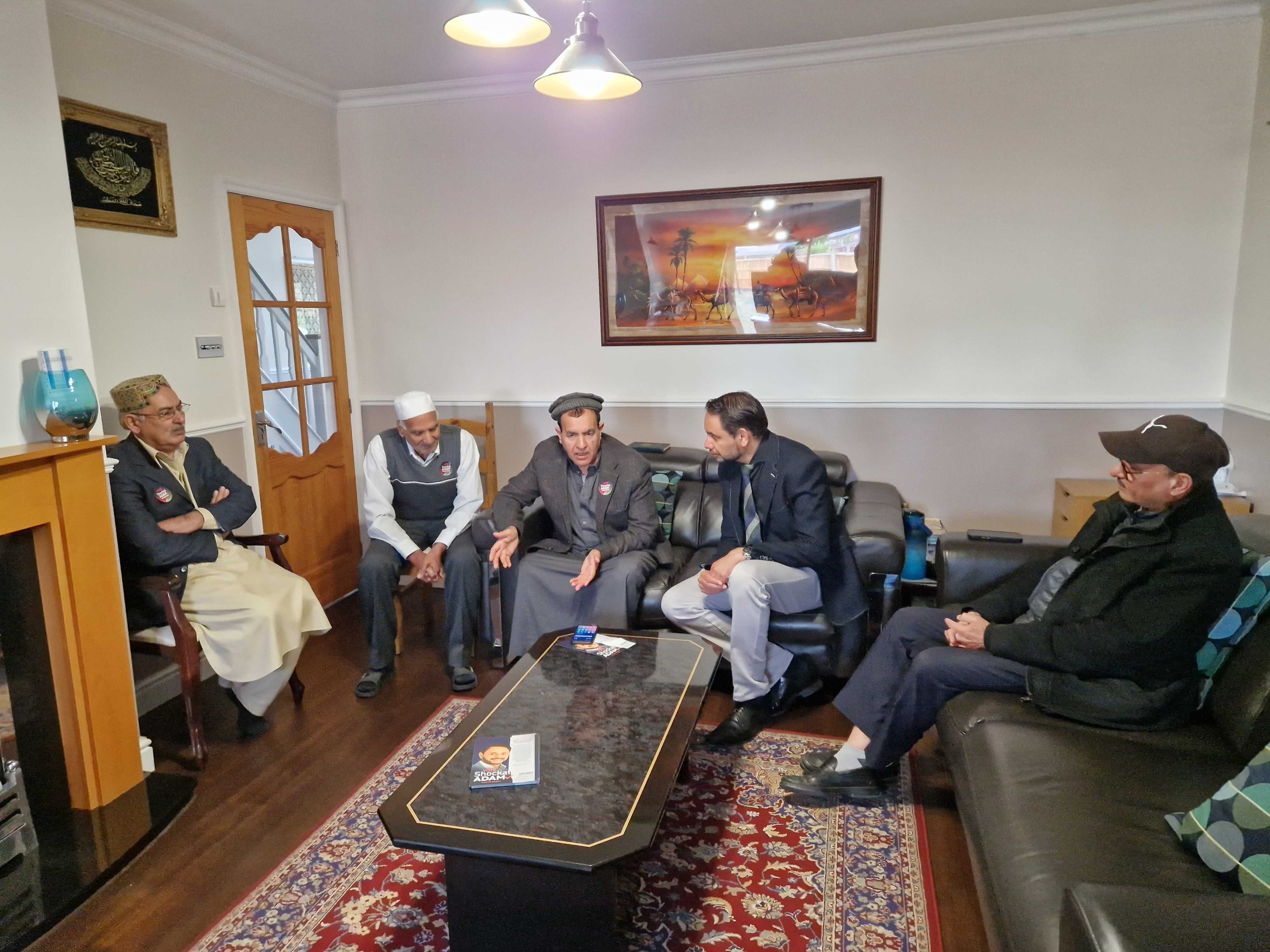 Mohammed Arif, general secretary of the British Pakistani Association Leicestershire (third from left) talks to then-candidate Shockat Adam in June 2024 (MEE/Imran Mulla)