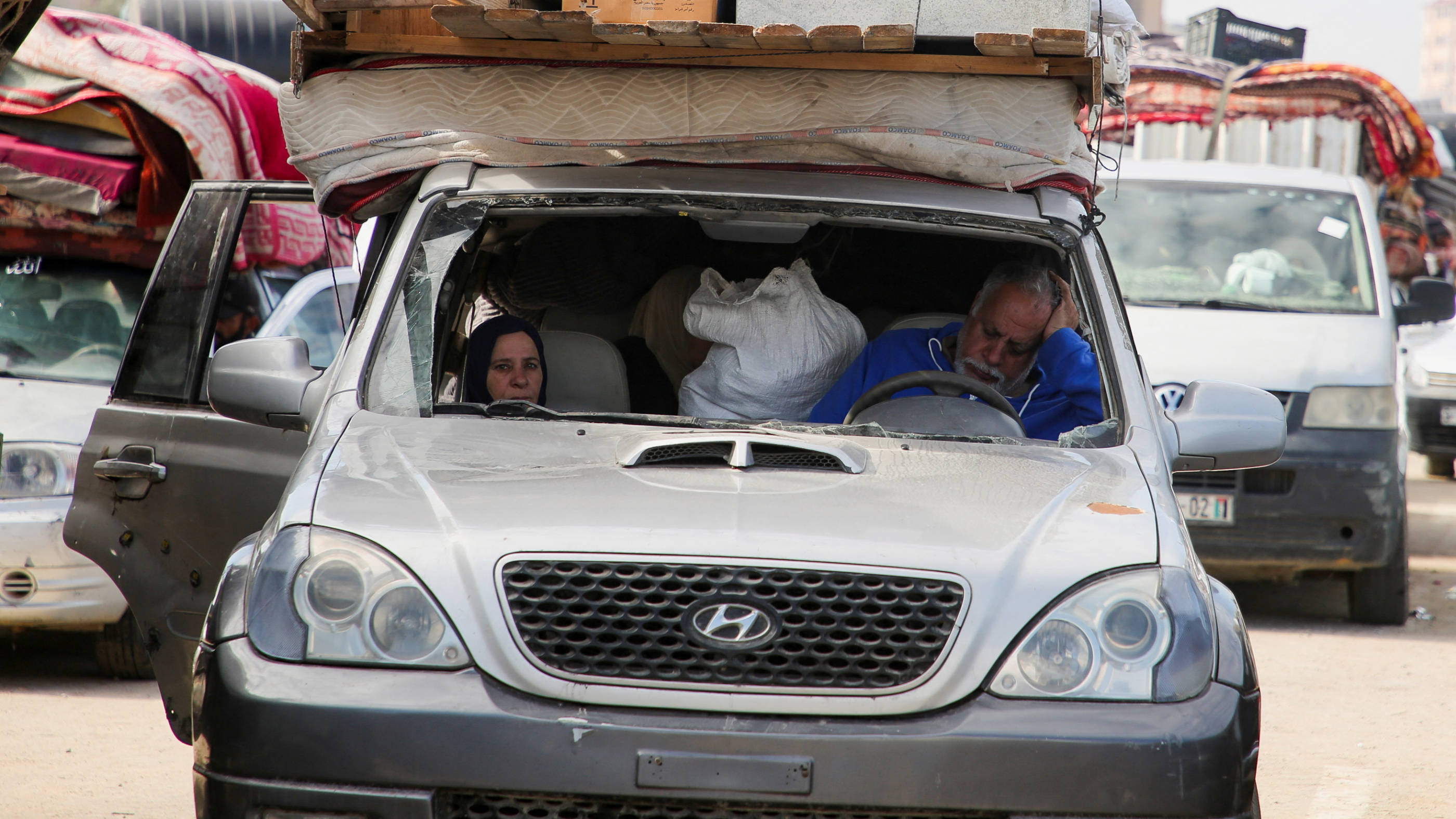 Displaced Palestinians sit in a vehicle as they wait to be allowed to return to their homes in northern Gaza, 26 January 2025 (Reuters)