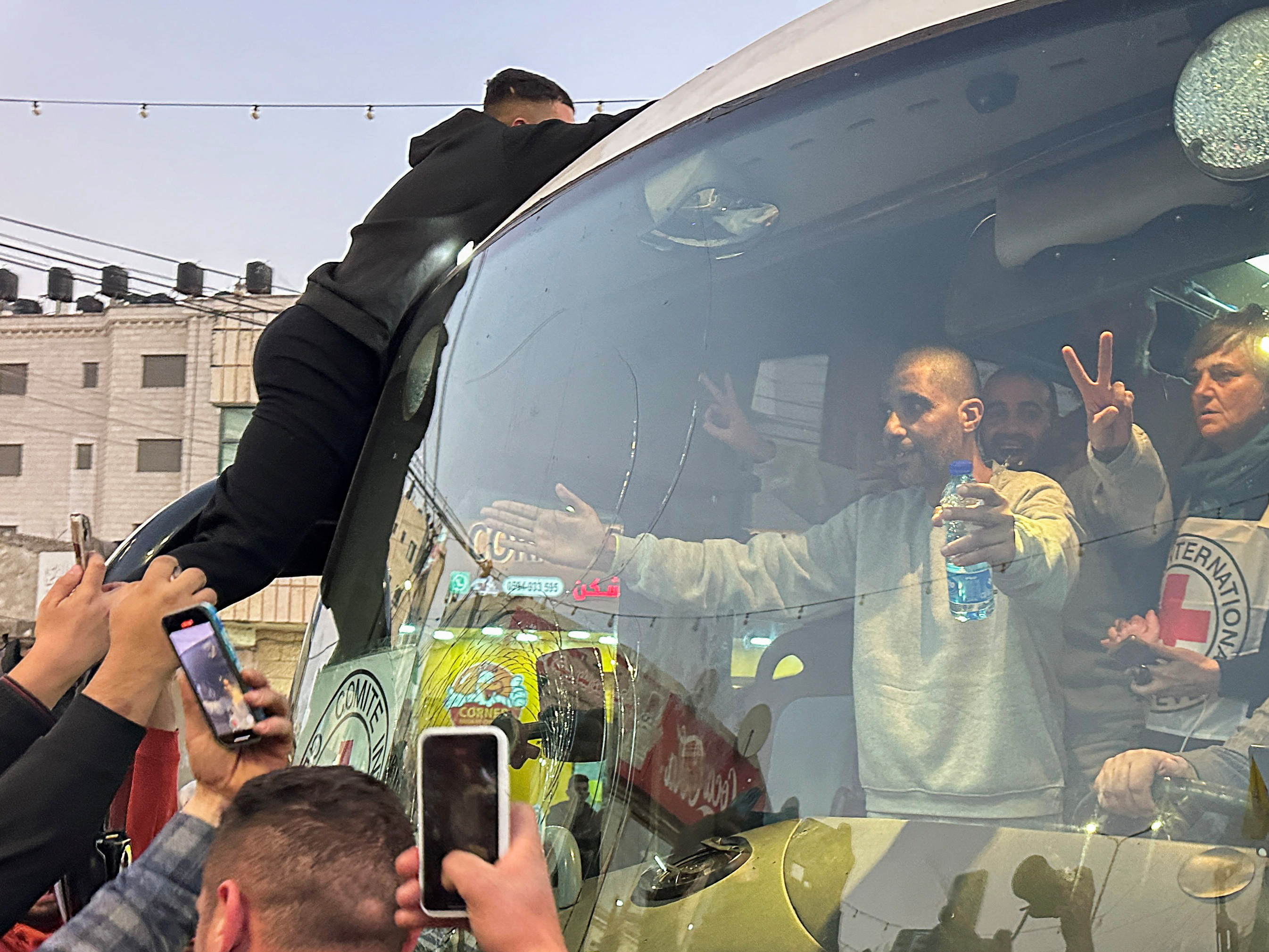 Free prisoner Zakaria Zubeidi gestures while in a vehicle near Ramallah in the occupied West Bank following his release from Israeli prison on 30 January (Reuters/Ali Sawafta)