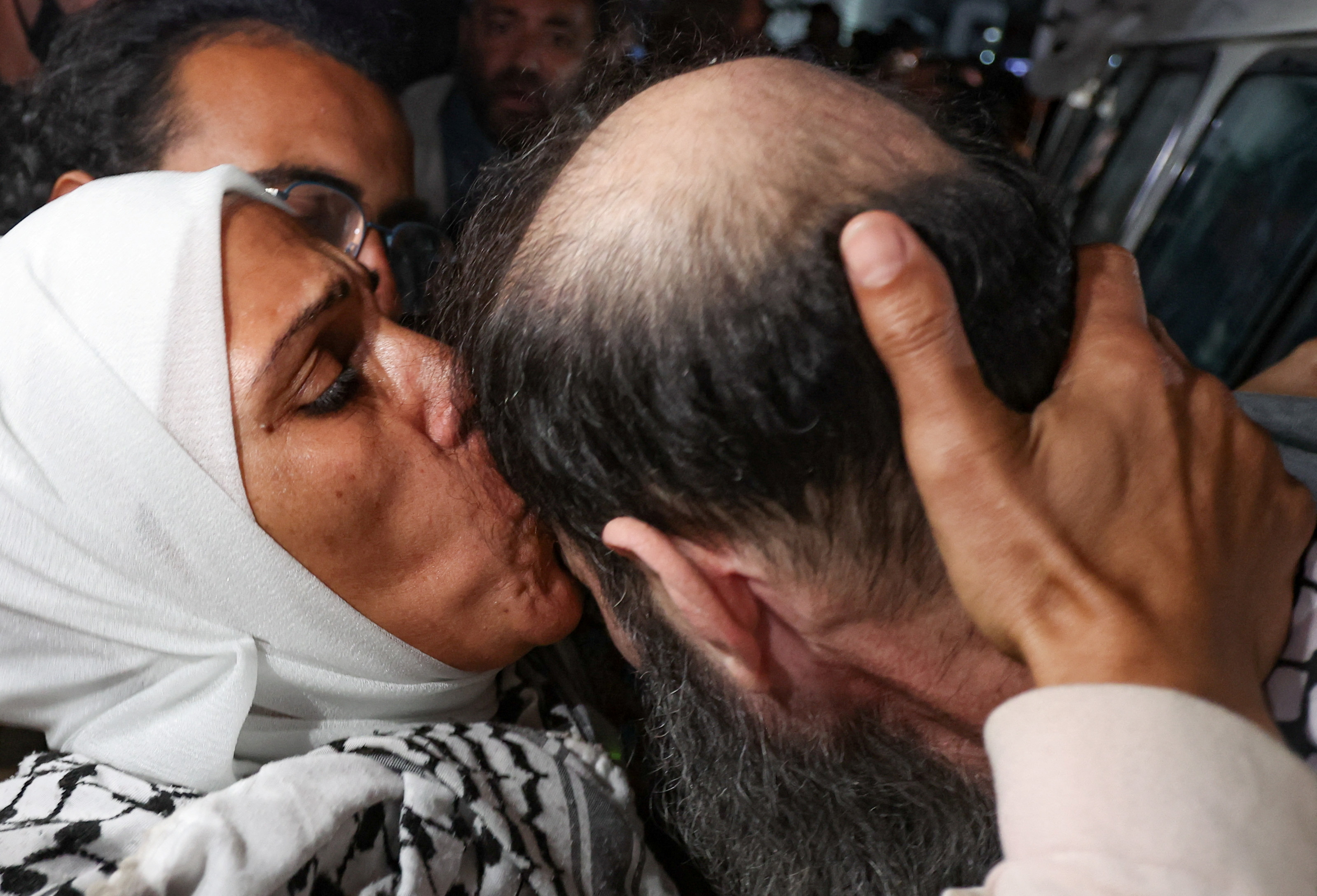 A woman kisses a freed Palestinian prisoner as he is welcomed in Khan Younis in the southern Gaza Strip after being released from an Israeli prison, on 30 January 2025 (Ramadan Abed/Reuters)
