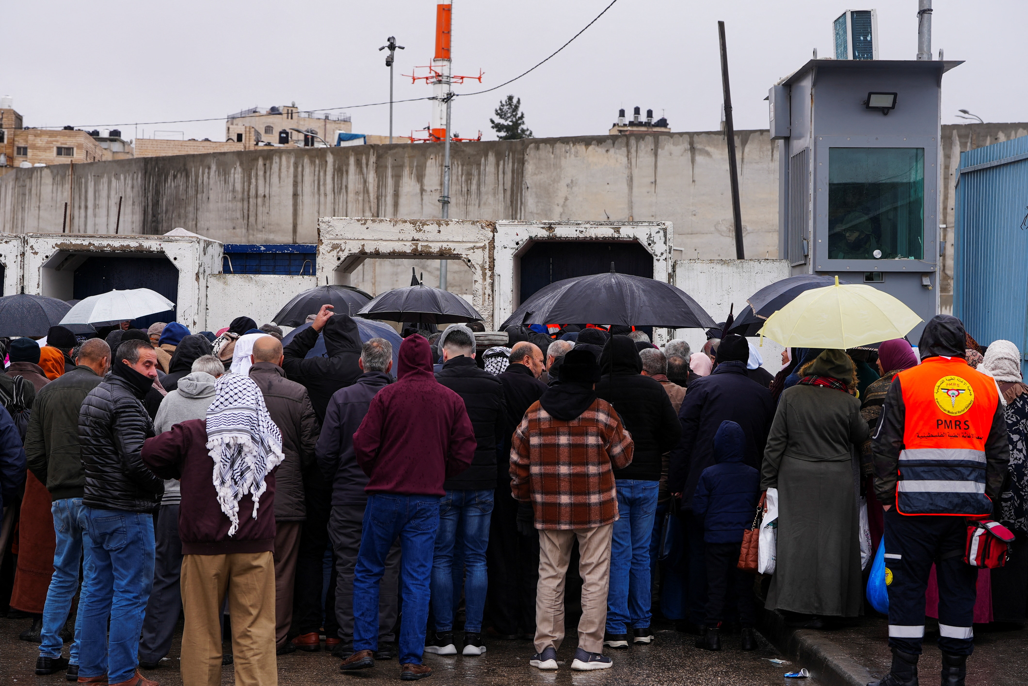 Palestinians queue at an Israeli checkpoint in Qalandiya, as they make their way to Al-Aqsa complex in Jerusalem's Old City, to attend the Friday prayers. (Reuters)