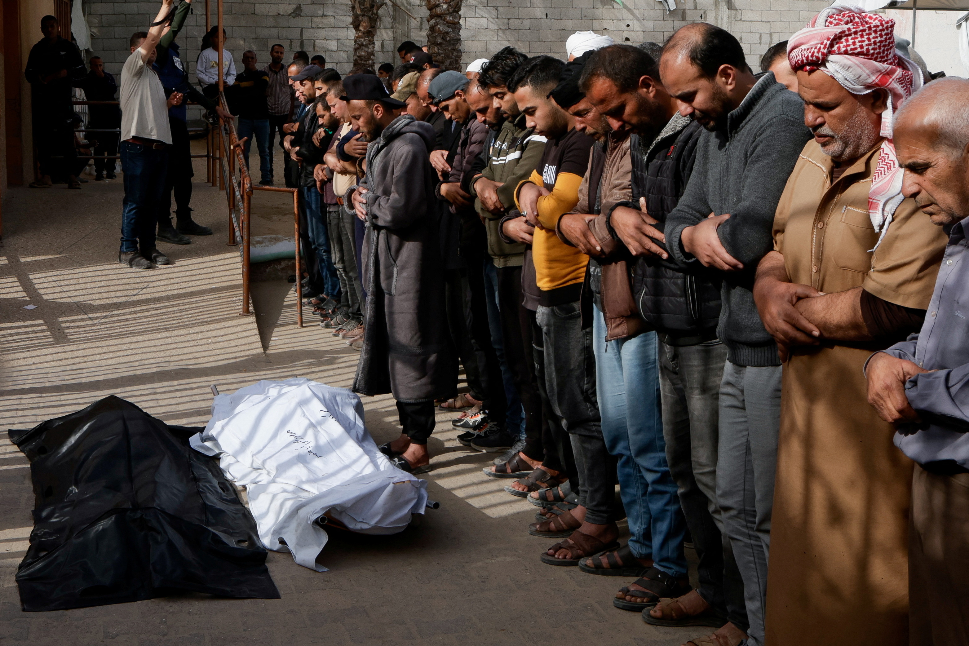 Mourners pray during the funeral of Palestinians killed in Israeli strikes, at Nasser hospital in Khan Younis, southern Gaza Strip, April 30, 2025. REUTERS/Hatem Khaled