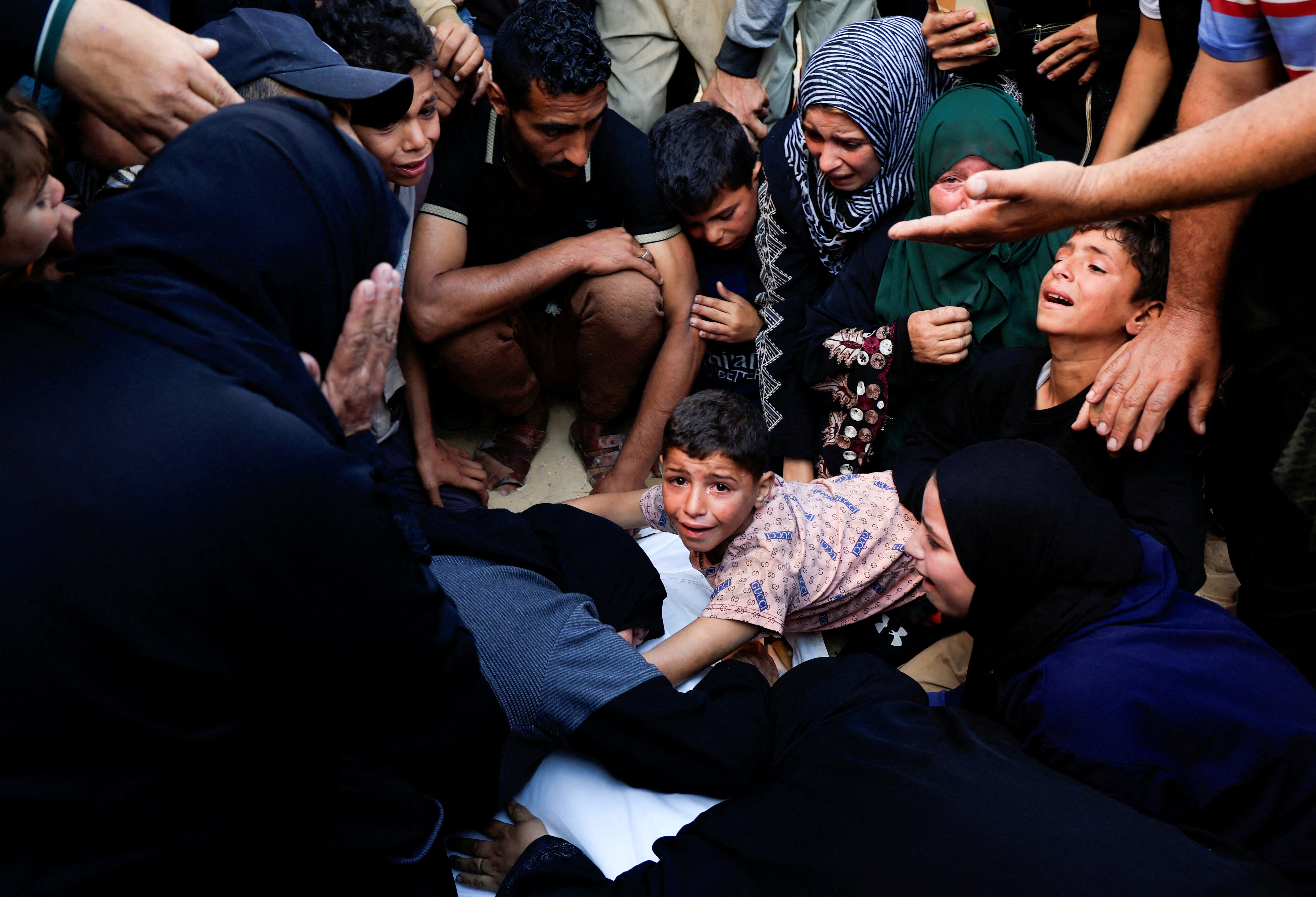 Mourners react as they attend the funeral of Palestinians killed in Israeli strikes, at Nasser hospital, in Khan Younis, in the southern Gaza Strip, May 23, 2025. REUTERS