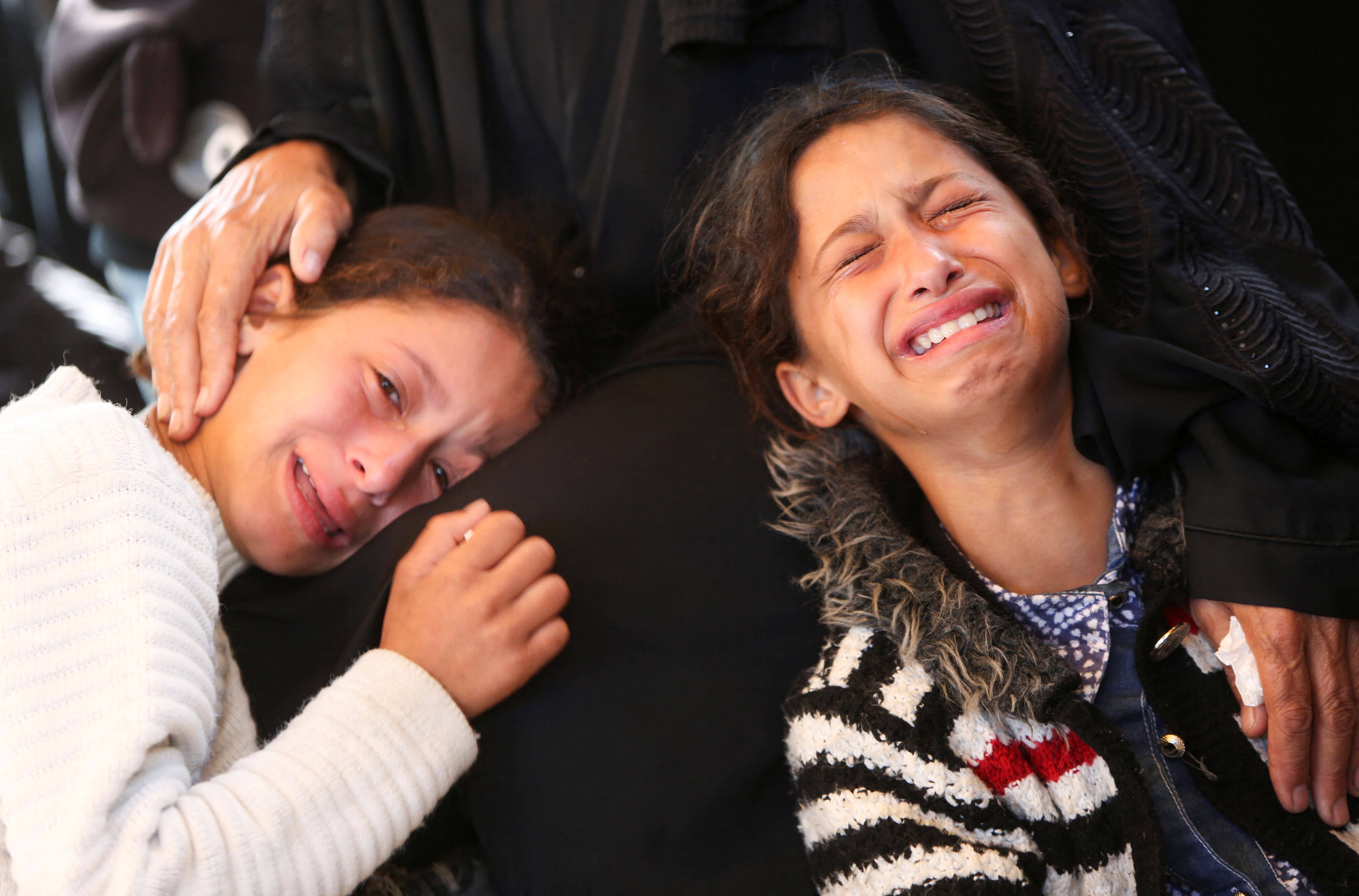 Girls react during the funeral of Palestinians who, according to medics, were killed in Israeli strikes, at Nasser hospital, in Khan Younis, in the southern Gaza Strip, June 2, 2025. 