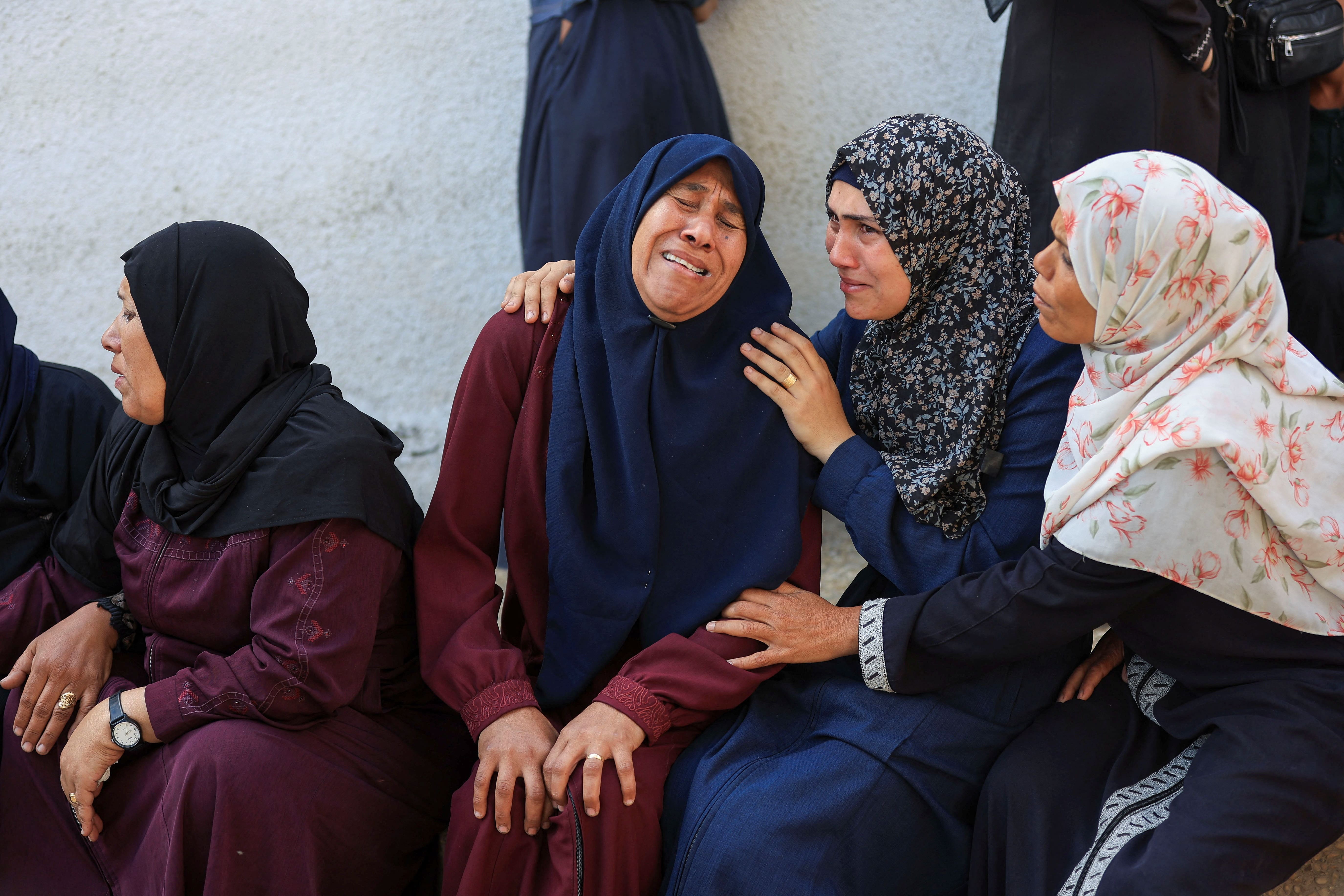 Mourners gather during the funeral of Palestinians who were killed, according to medics, in Israeli strikes, at Al-Shifa hospital, in Gaza City, June 4, 2025. REUTERS