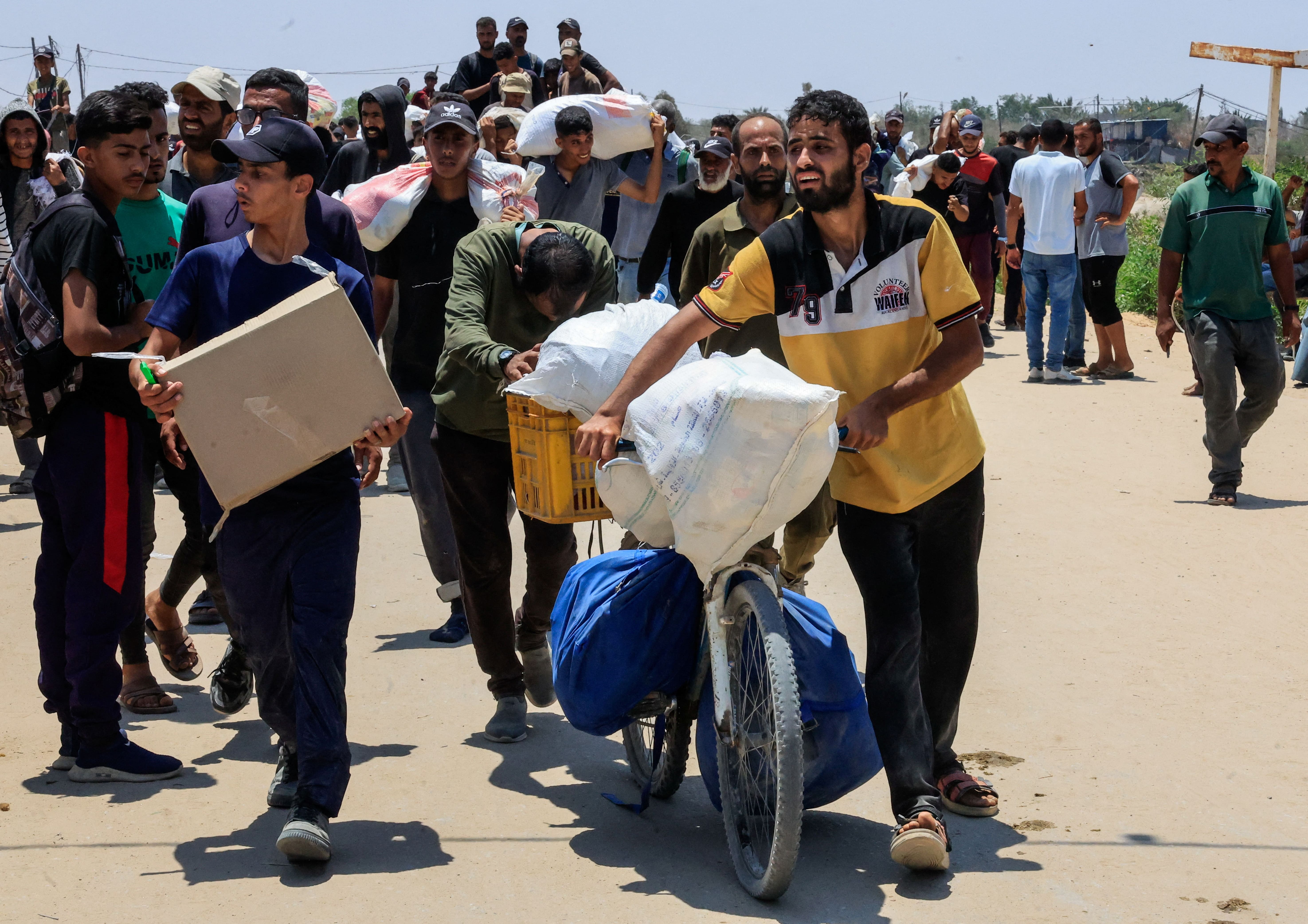 Palestinians collect aid supplies from the U.S.-backed Gaza Humanitarian Foundation, in Rafah, in the southern Gaza Strip, June 9, 2025. REUTERS