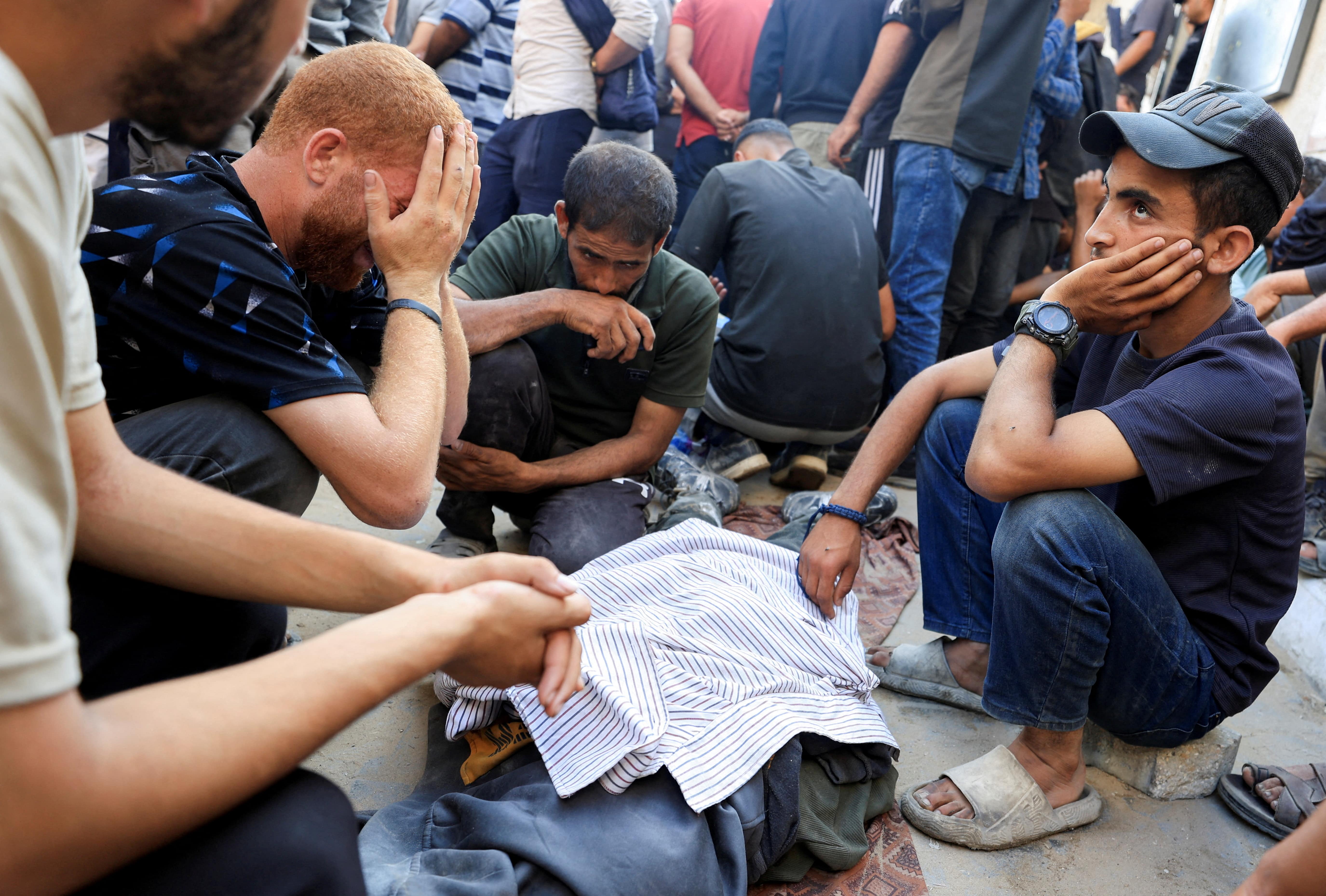 Mourners attend the funeral of Palestinians killed in Israeli attacks on a school sheltering displaced people and on people seeking aid, according to Gaza's health ministry, at Al-Shifa Hospital in Gaza City, July 3, 2025. REUTERS/Dawoud Abu Alkas TPX IMAGES OF THE DAY