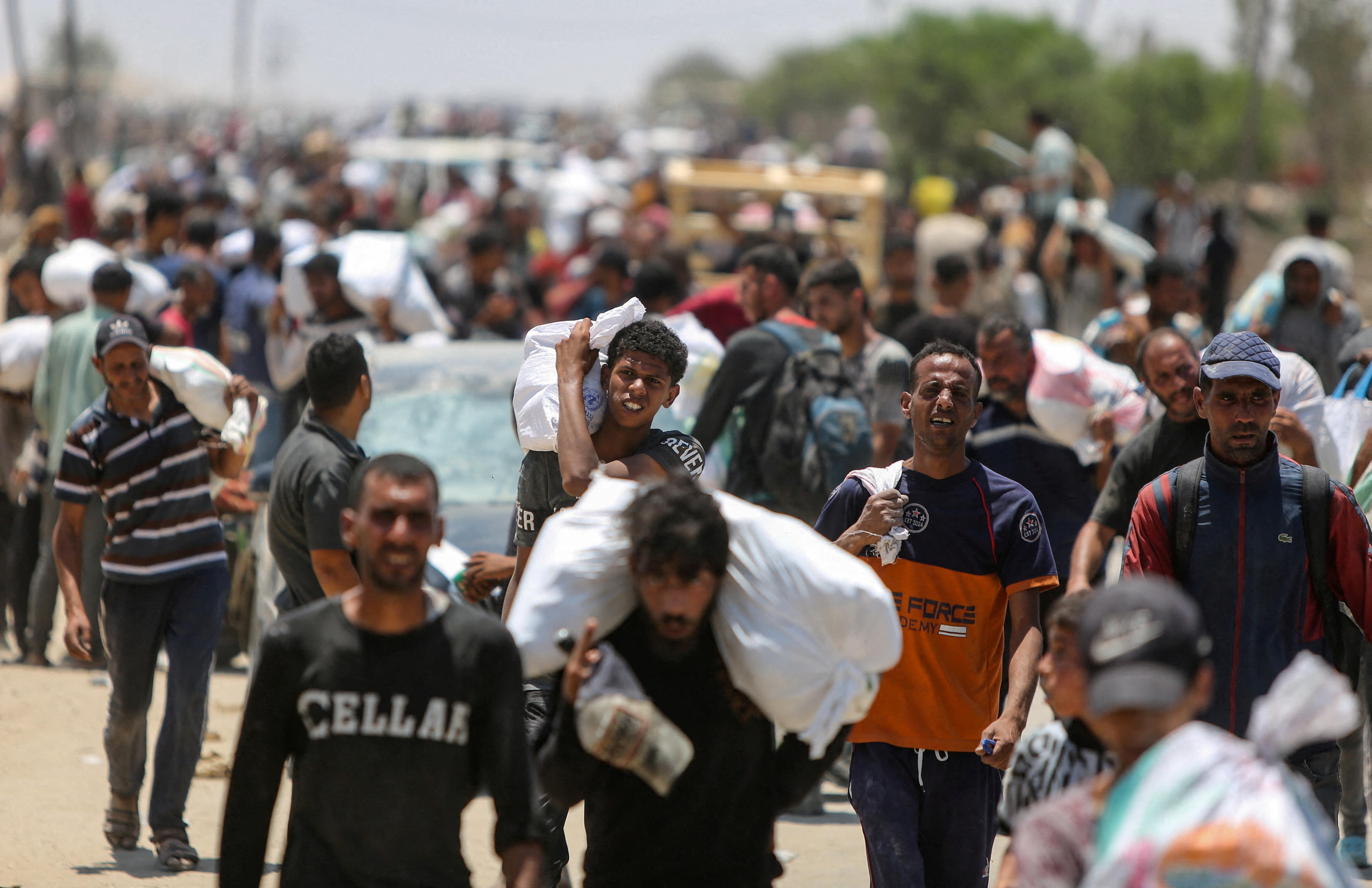 Palestinians collect aid supplies from the U.S.-backed Gaza Humanitarian Foundation, in Rafah, in the southern Gaza Strip, June 9, 2025. REUTERS