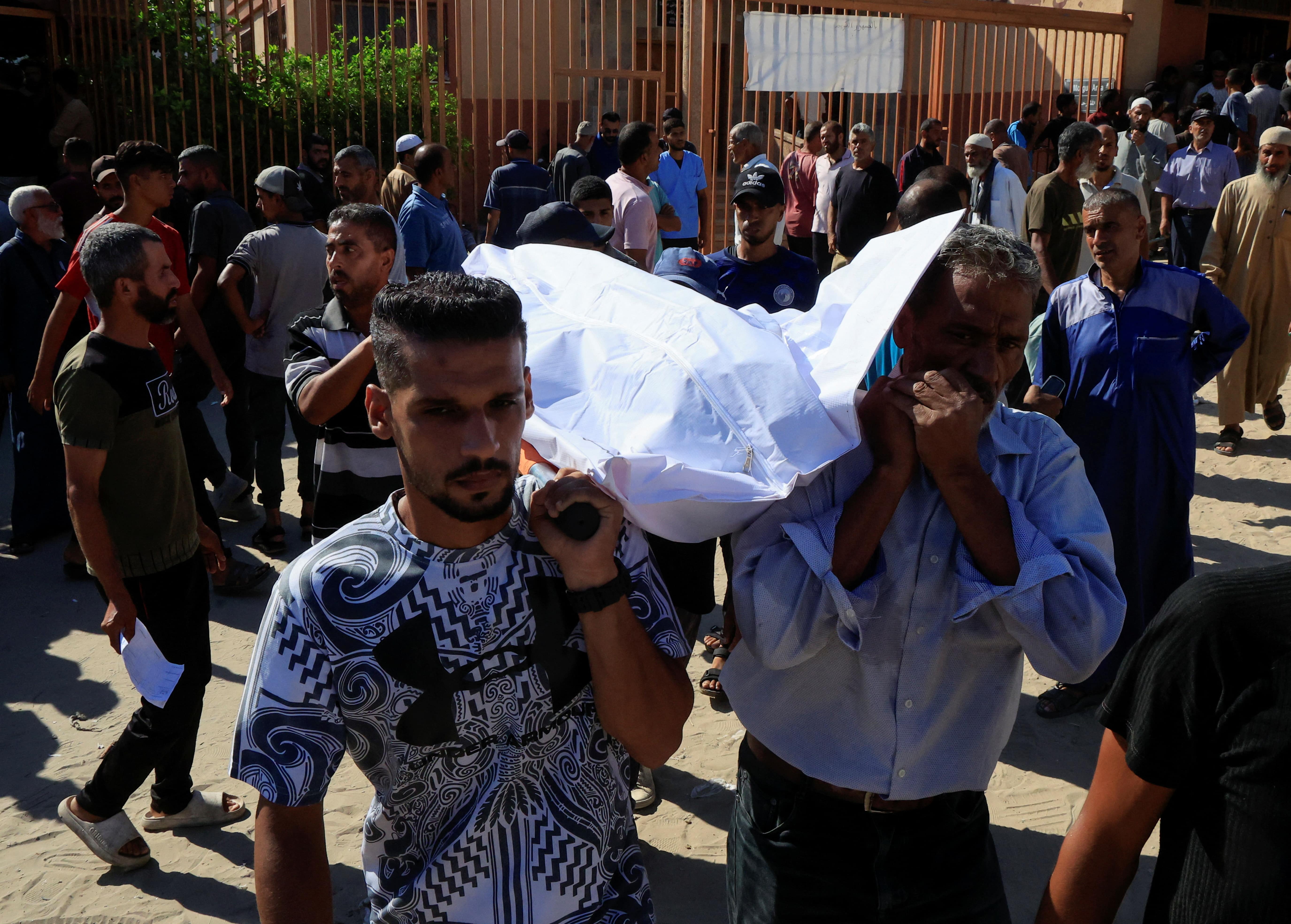 People carry a body as they mourn Palestinians who were killed in an incident on Wednesday while seeking aid in Khan Younis, at Nasser hospital in Khan Younis in the southern Gaza Strip July 16, 2025.