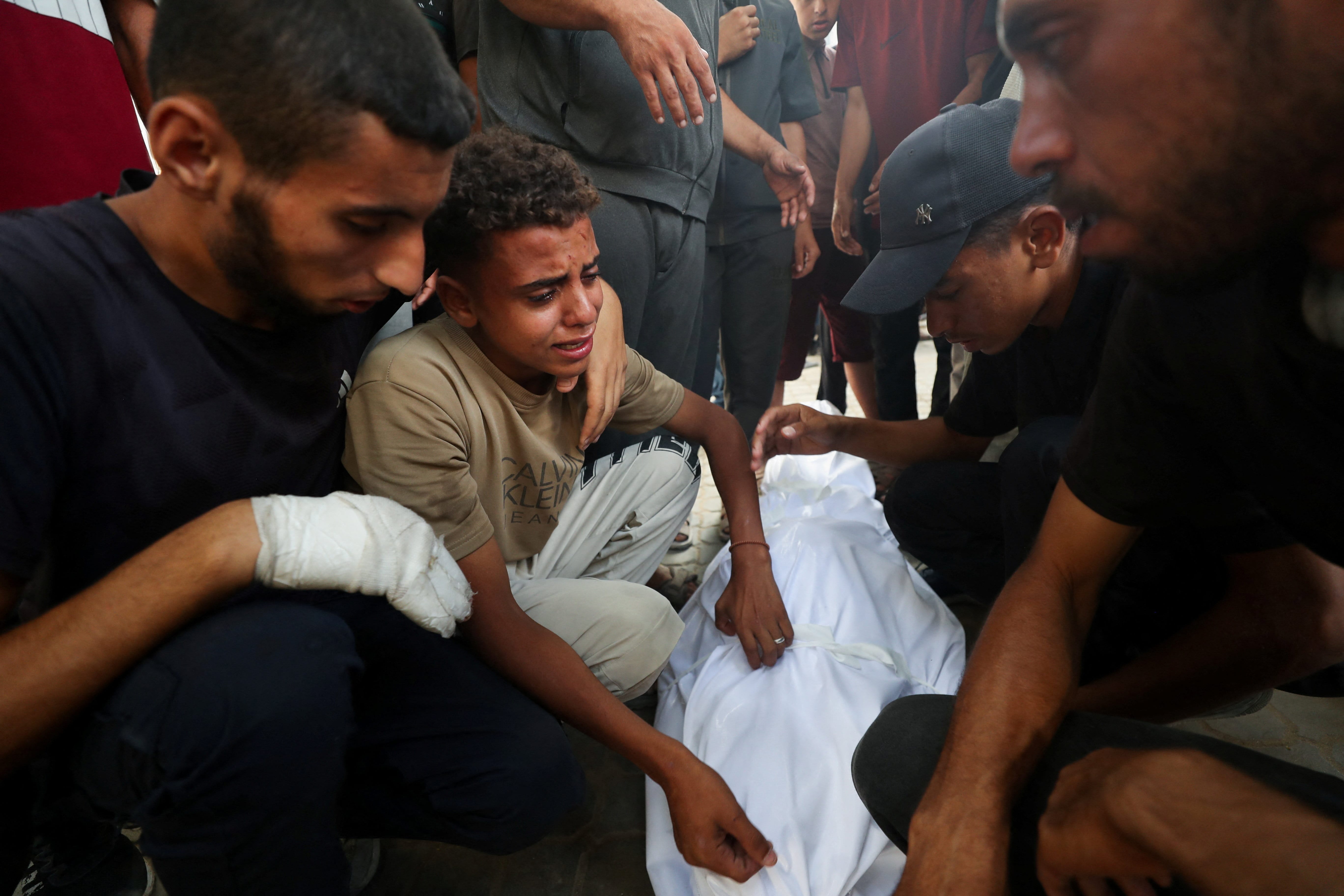 Mourners attend the funeral of Palestinians, who were killed by Israeli fire while trying to receive aid on Tuesday, according to medics, at Al-Shifa Hospital, in Gaza City, July 30, 2025. (Reuters)