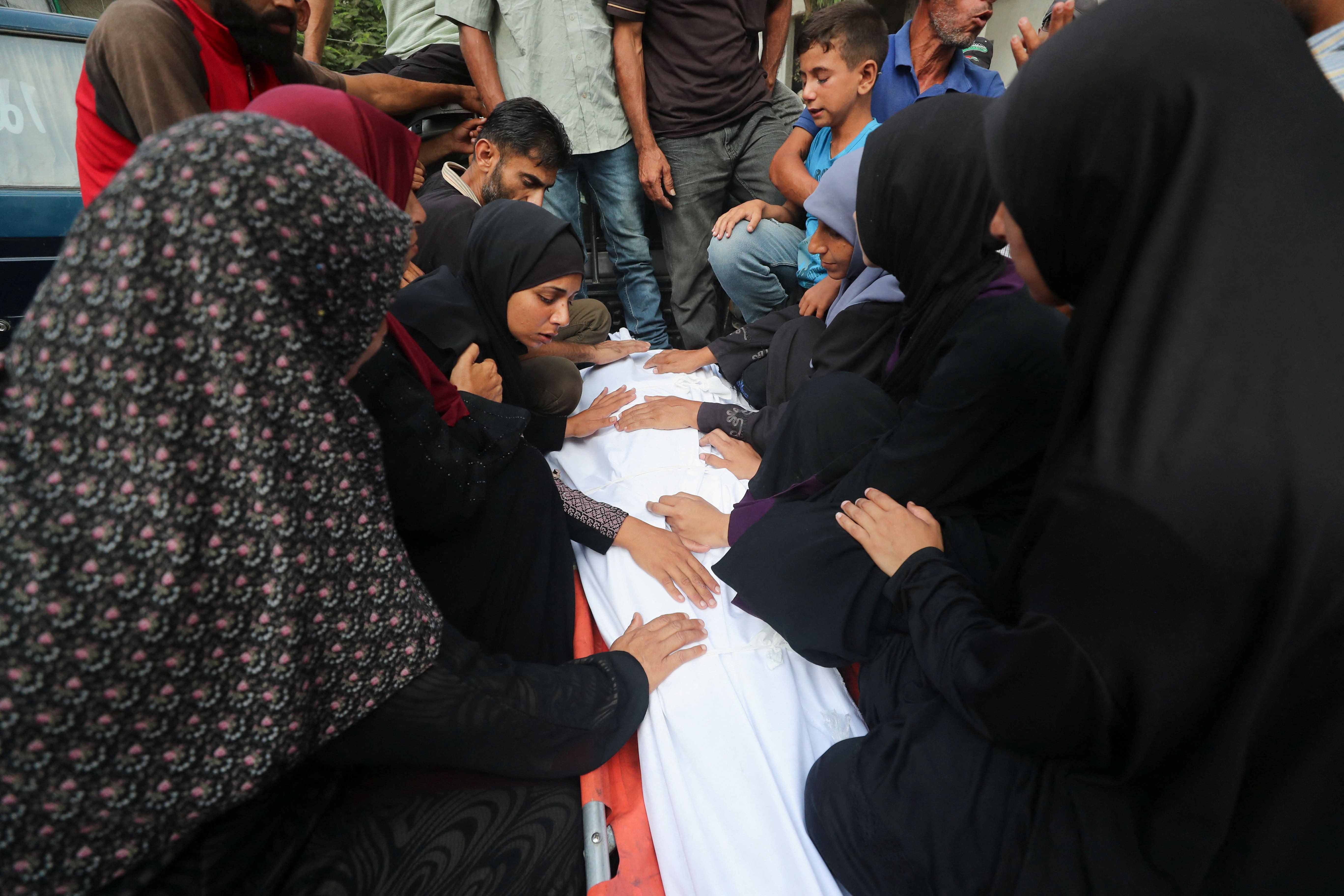 Mourners attend the funeral of Palestinians, who were killed by Israeli fire while trying to receive aid on Tuesday, according to medics, at Al-Shifa Hospital, in Gaza City, July 30, 2025. REUTERS