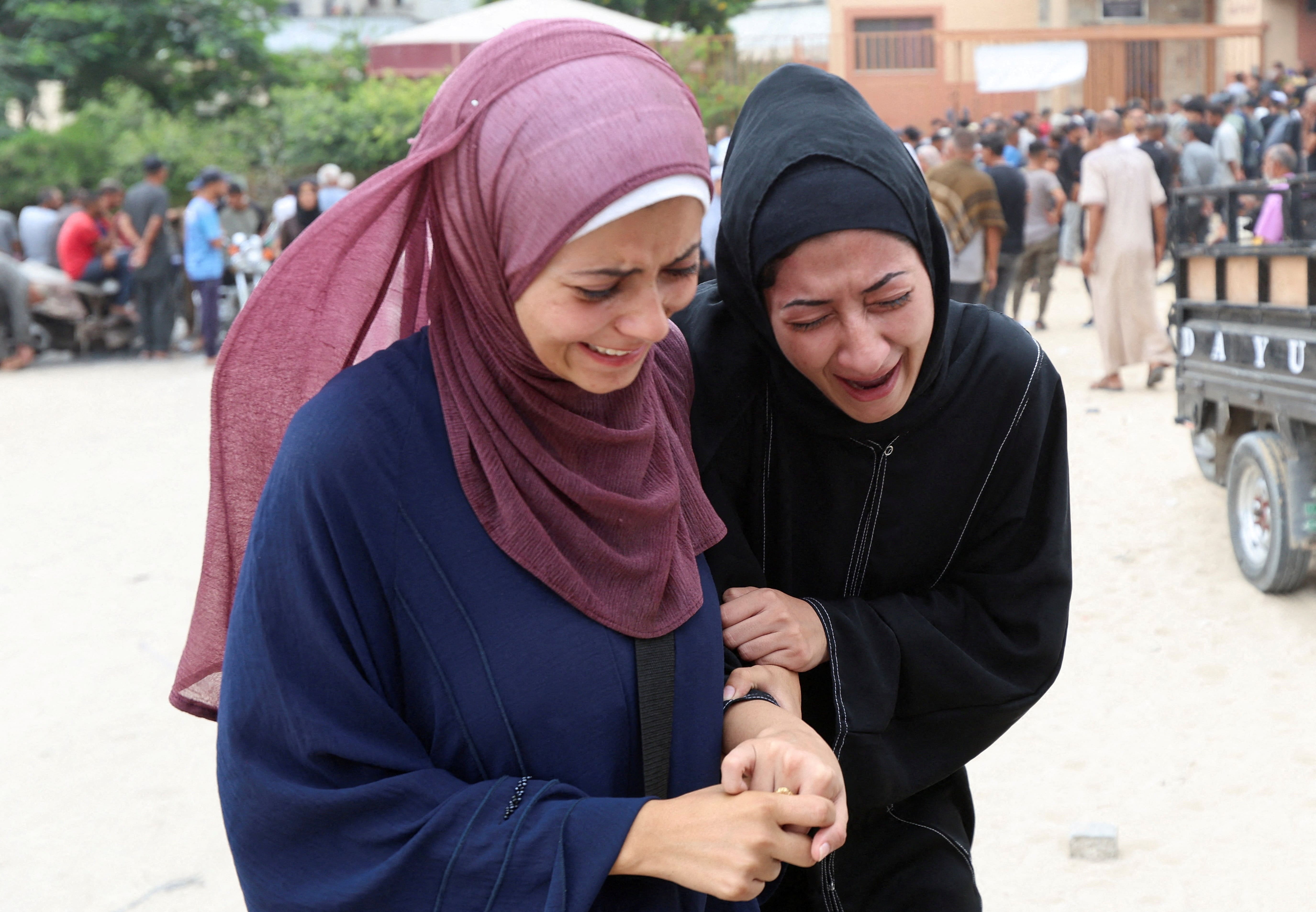 Mourners react during the funeral of Palestinians, who were killed by Israeli fire while trying to receive aid on Thursday, and who were killed in overnight Israeli airstrikes on tents, according to medics, at Nasser Hospital in Khan Younis, southern Gaza Strip, August 1, 2025. REUTERS