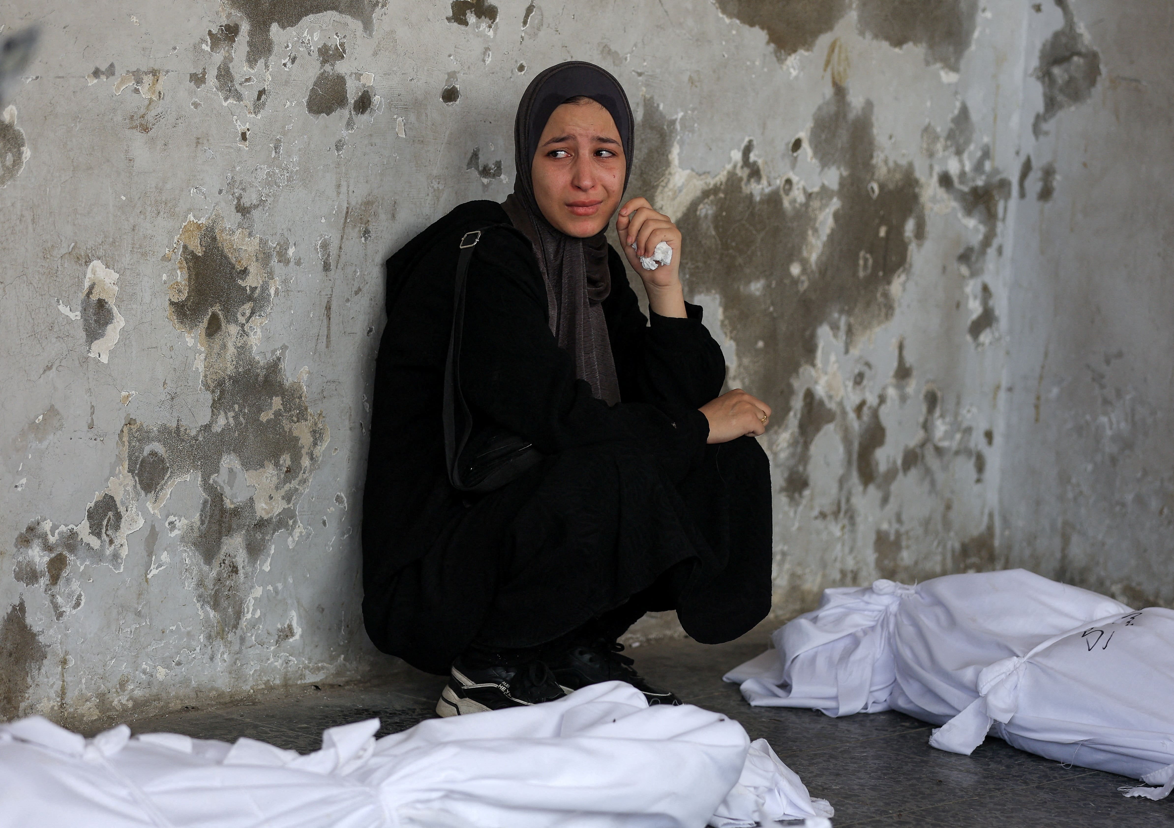 A mourner attends the funeral of Palestinians killed in Israeli strikes, according to medics, at Al-Ahli Arab Hospital in Gaza City August 12, 2025. REUTERS