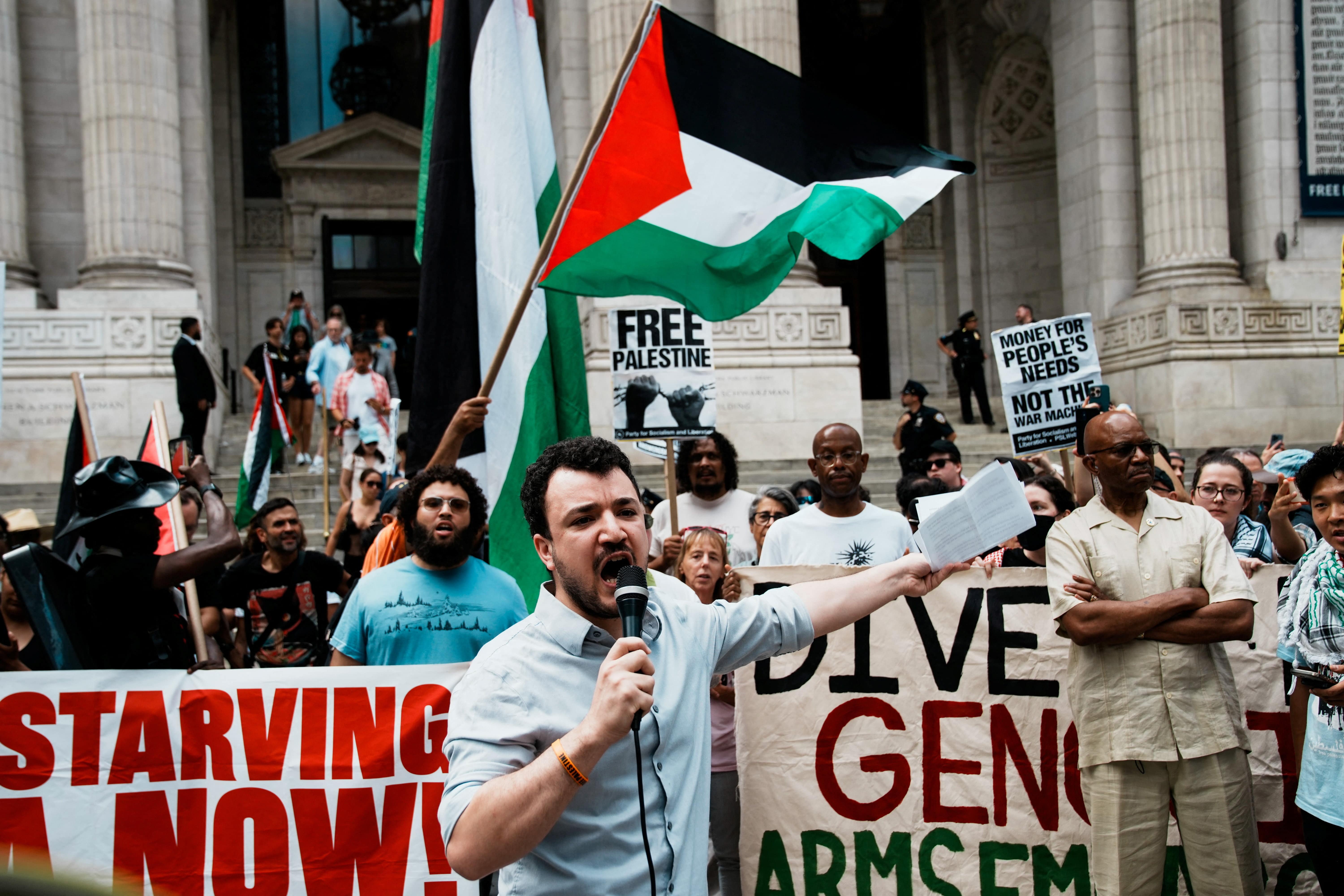 Mahmoud Khalil speaks to people as they gather at Bryant Park, to participate in a 
